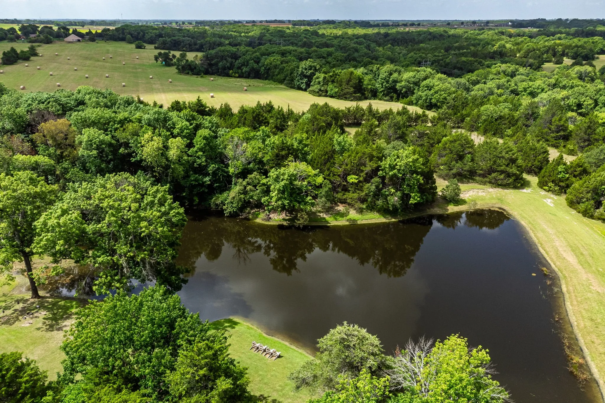 Aerial view of the Lake Saint Michael showing the trees, and groomed grounds surrounding the lake.
