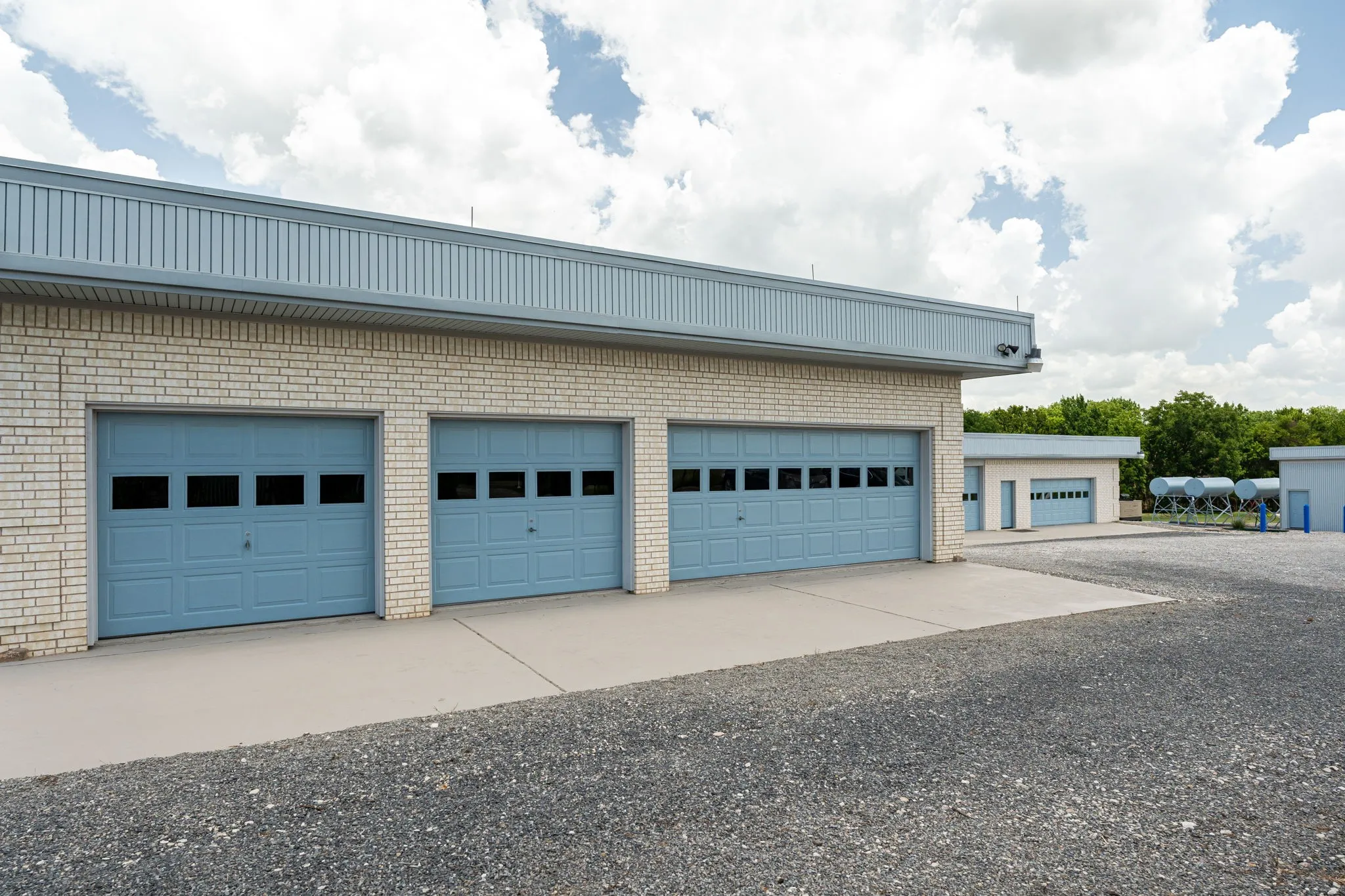 Abundance of enclosed garage parking in two 4-car garage structures with a total space for 8 cars- that will protect your riding tractors and other vehicles, riding equipment.  Ideal for a classic car collector to give protection form the elements. One of the garages has a half bathroom and hot water heater.  These are approximately 2,100 sf & 960 sf in size.