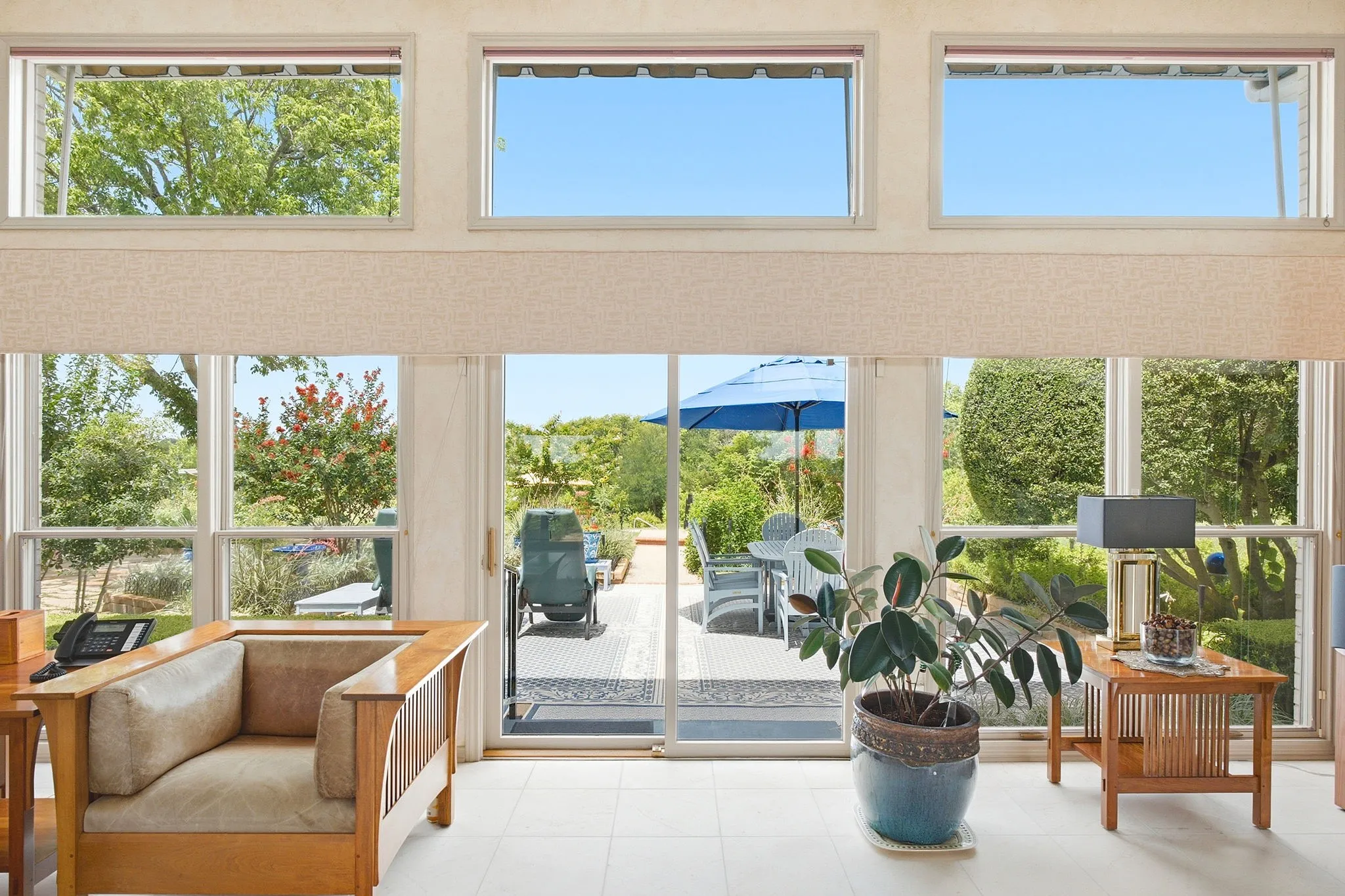 View from the living room showing the Pella doors and windows looking out to the patio area. Ceiling height of 10 feet and 12 feet present throughout the home.