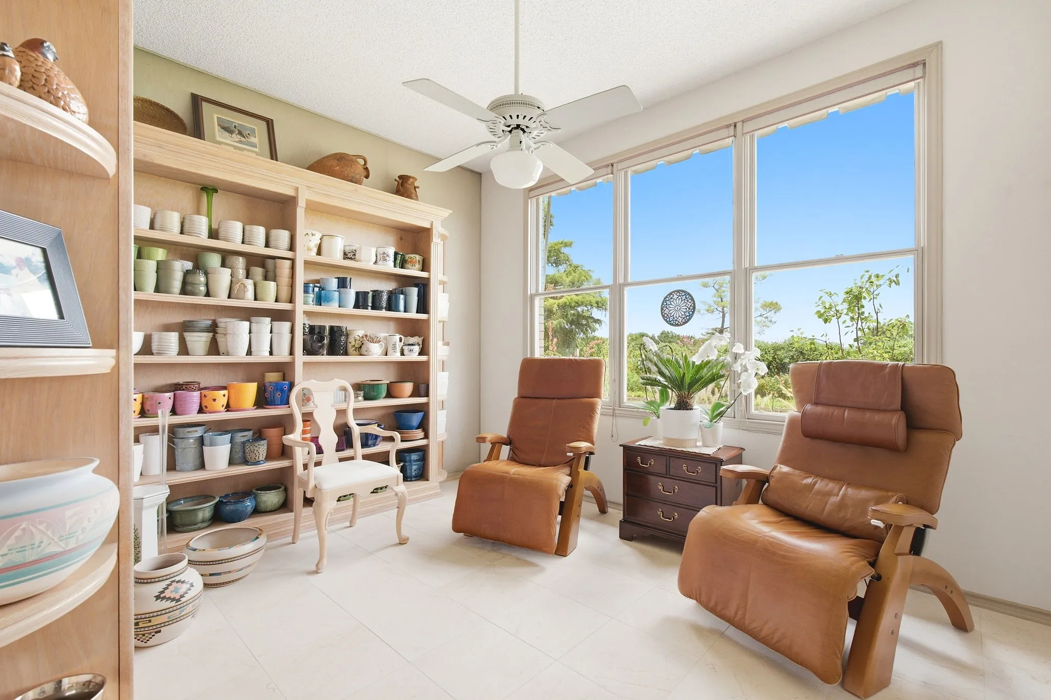 In addition to the primary bedroom there are two bedrooms with a full bathroom conveniently accessible next to them.  The display shelves are not built-in.  The room is currently serving as a sitting and reading room.