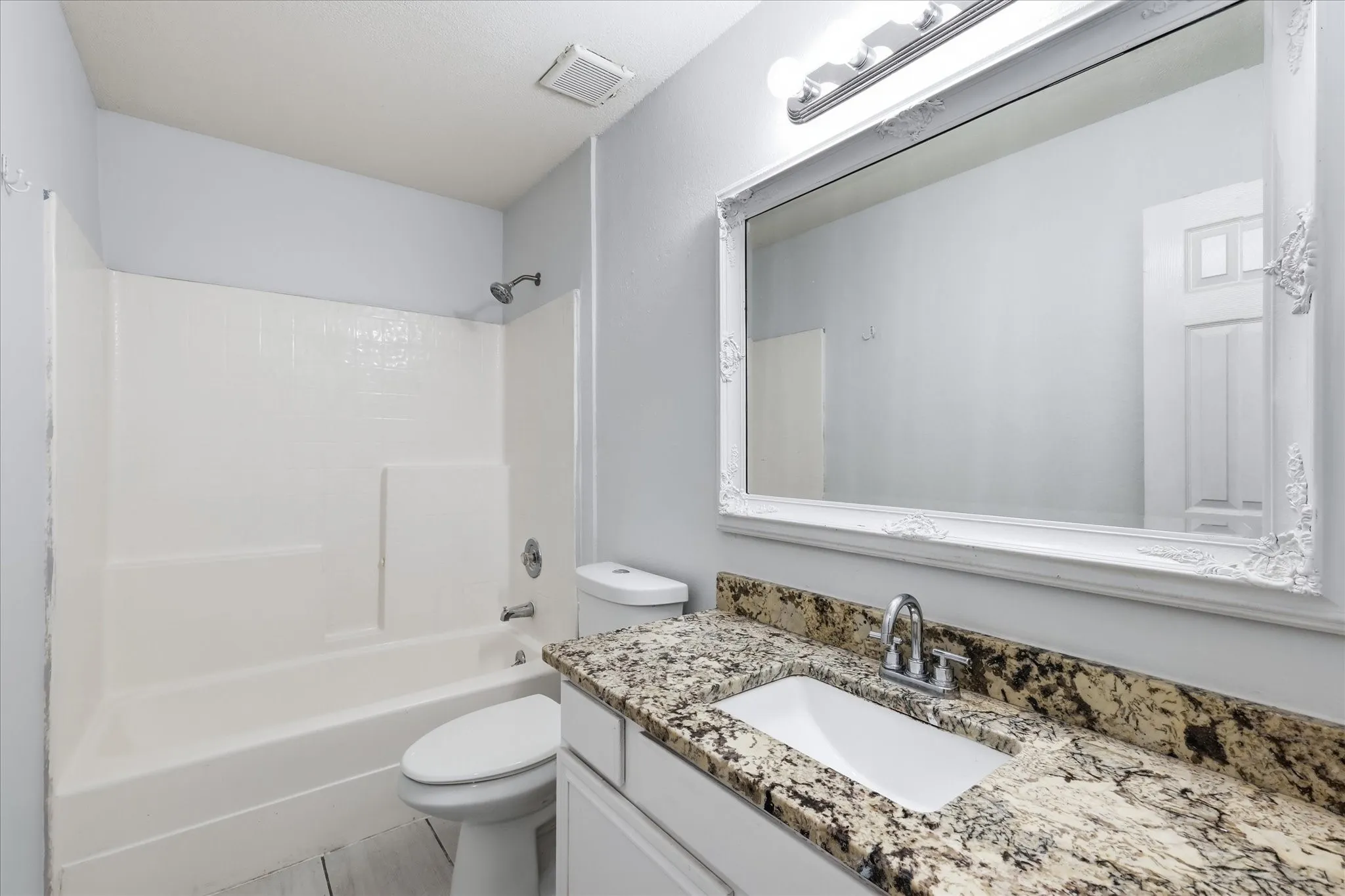  Full-sized secondary bathroom with luxury vinyl plank flooring serving the guest bedrooms