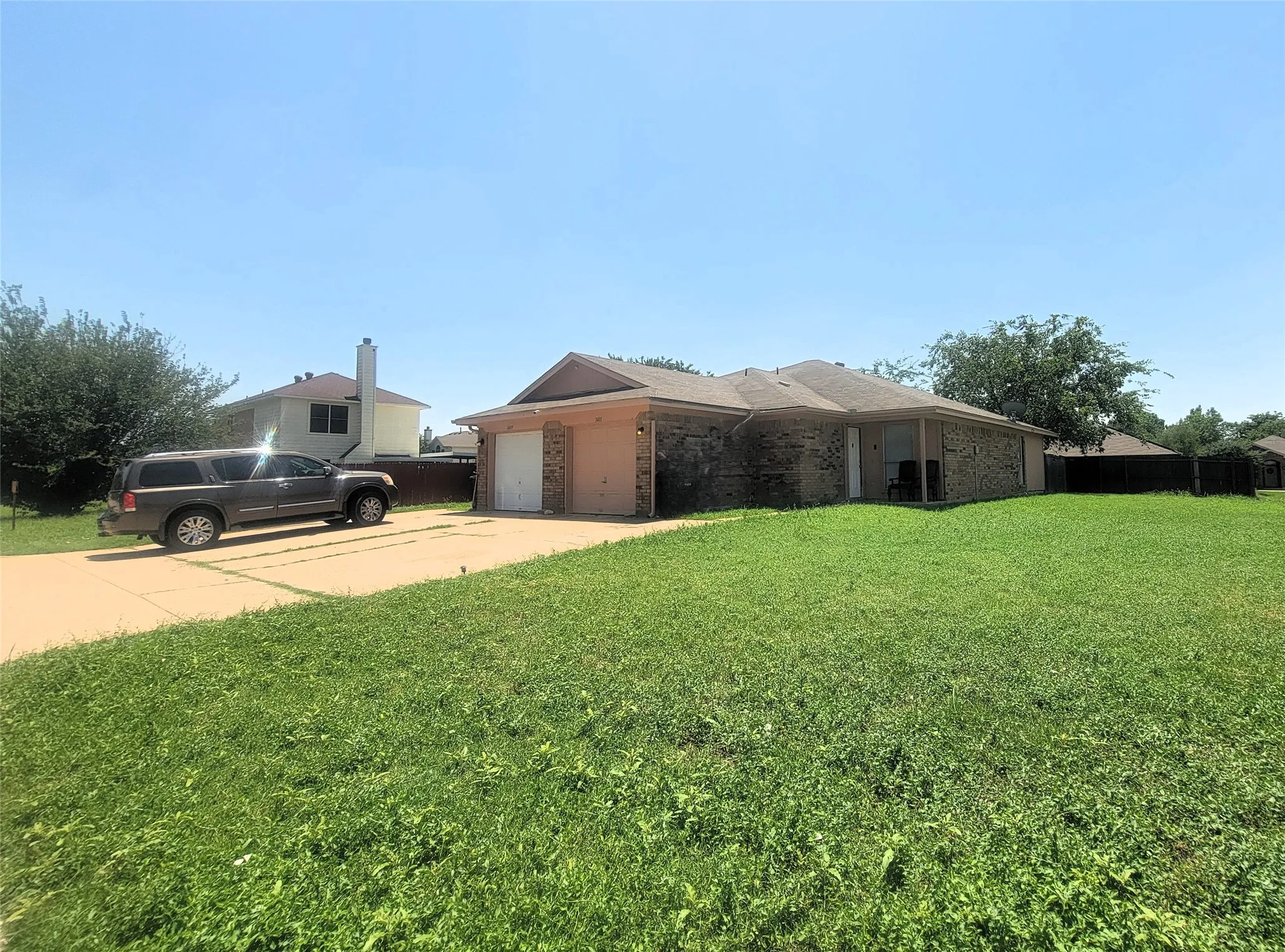 Single-story residence featuring a brick and siding exterior, an attached two-car garage, and a concrete driveway
