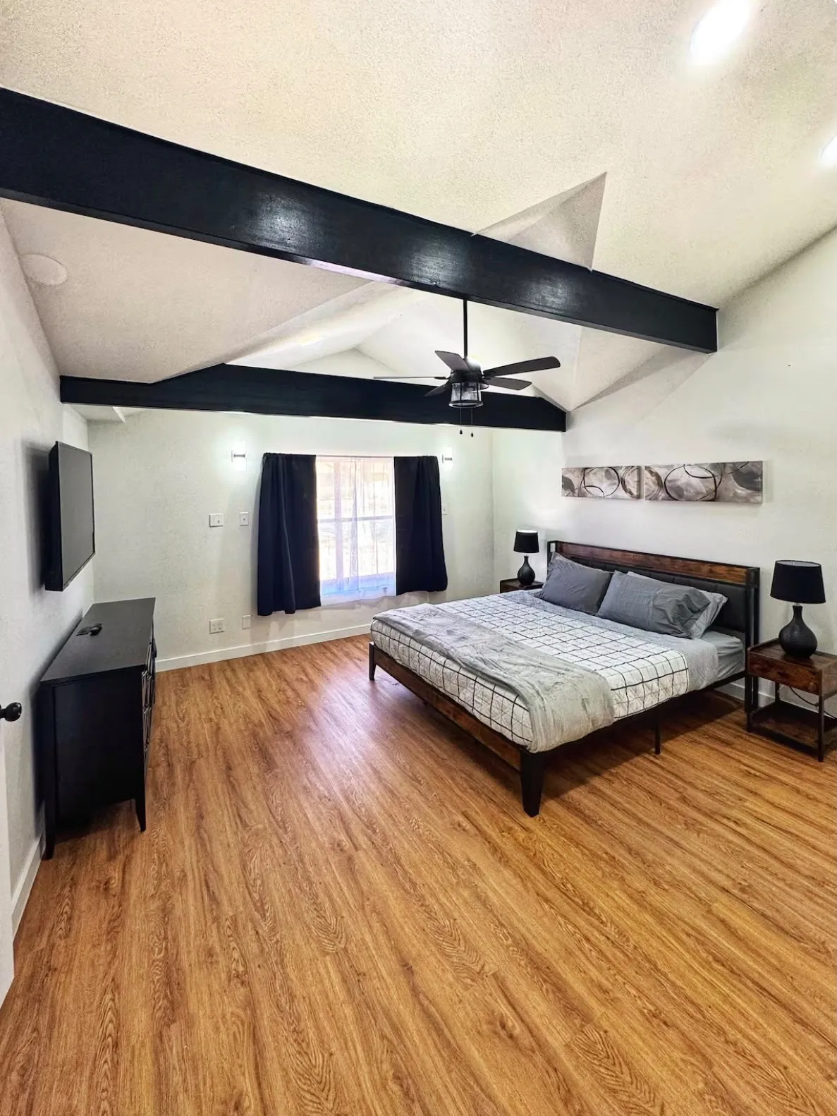 Vaulted ceiling featuring exposed black beams