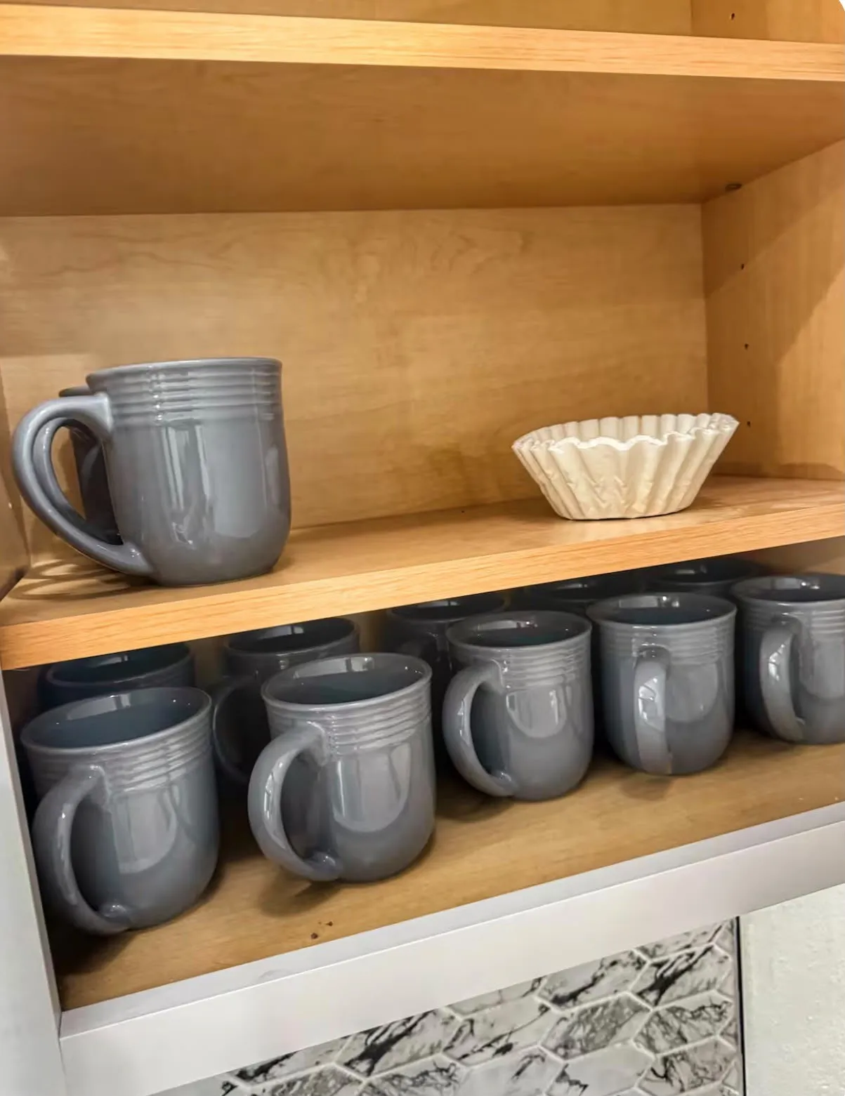 Light wood-finish cabinetry featuring adjustable shelving