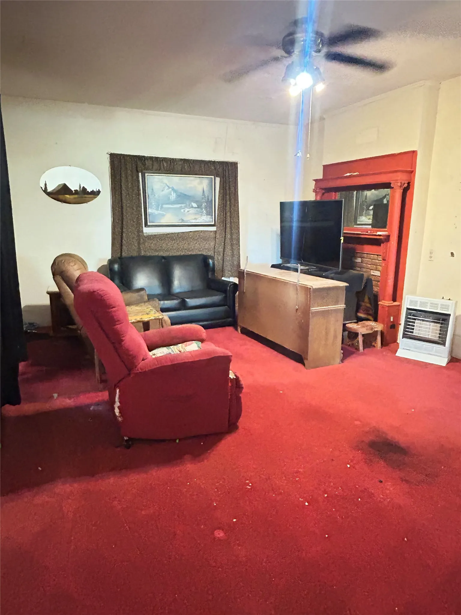 Your Living Room with 2 large windows and a fireplace.
