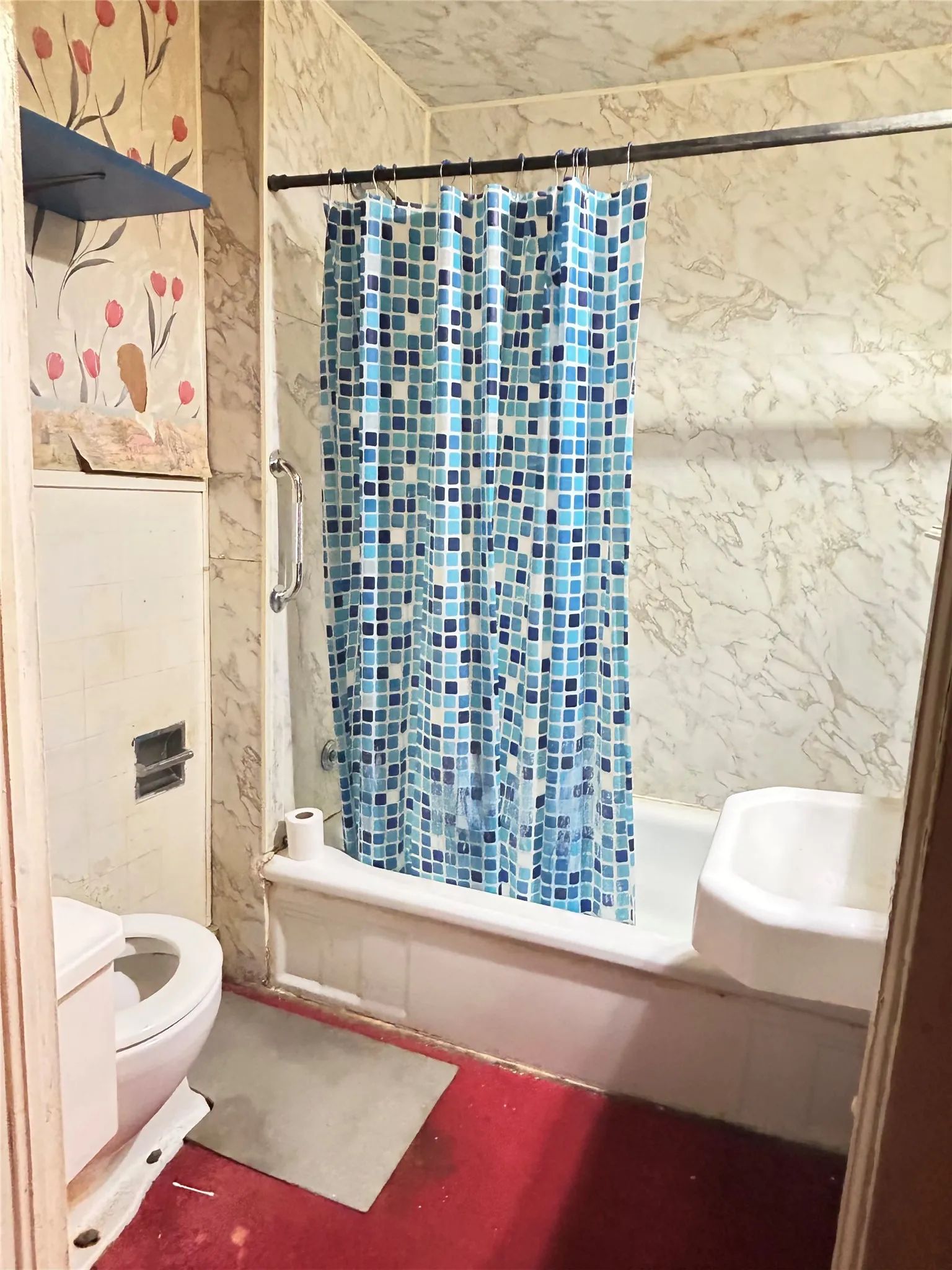  A hall bathroom complete with commode, sink, and tub shower.