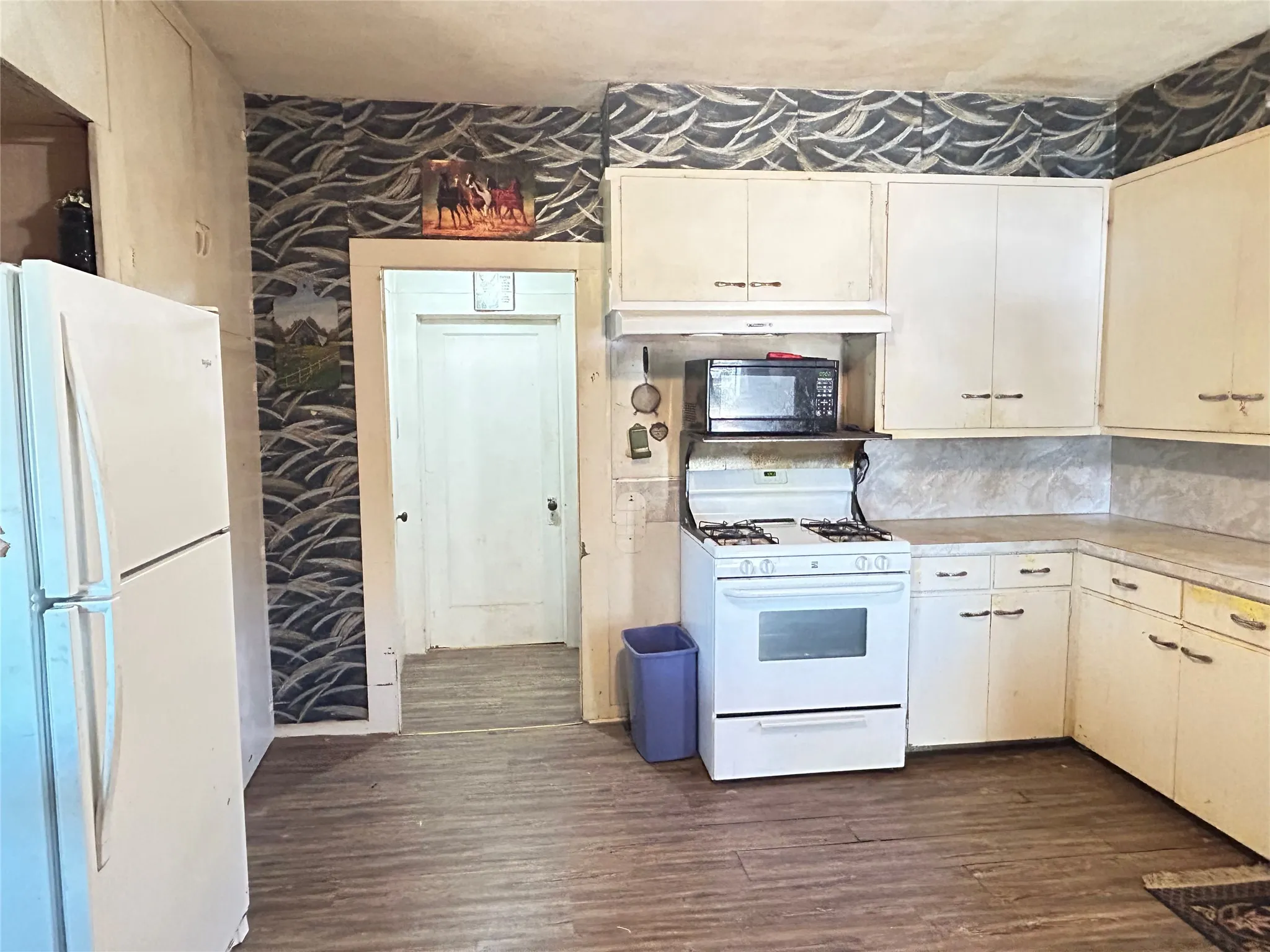 Open floor space with nice vinyl flooring & good lighting in the kitchen.