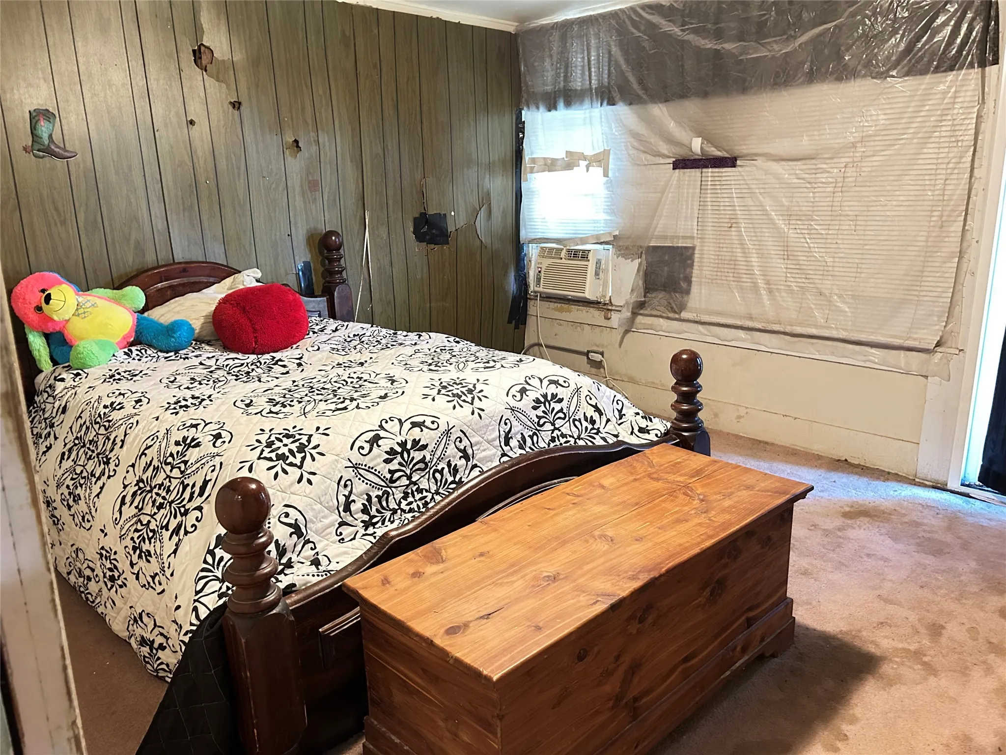  Secondary Bedroom with paneling walls, carpet, and window air conditioning.