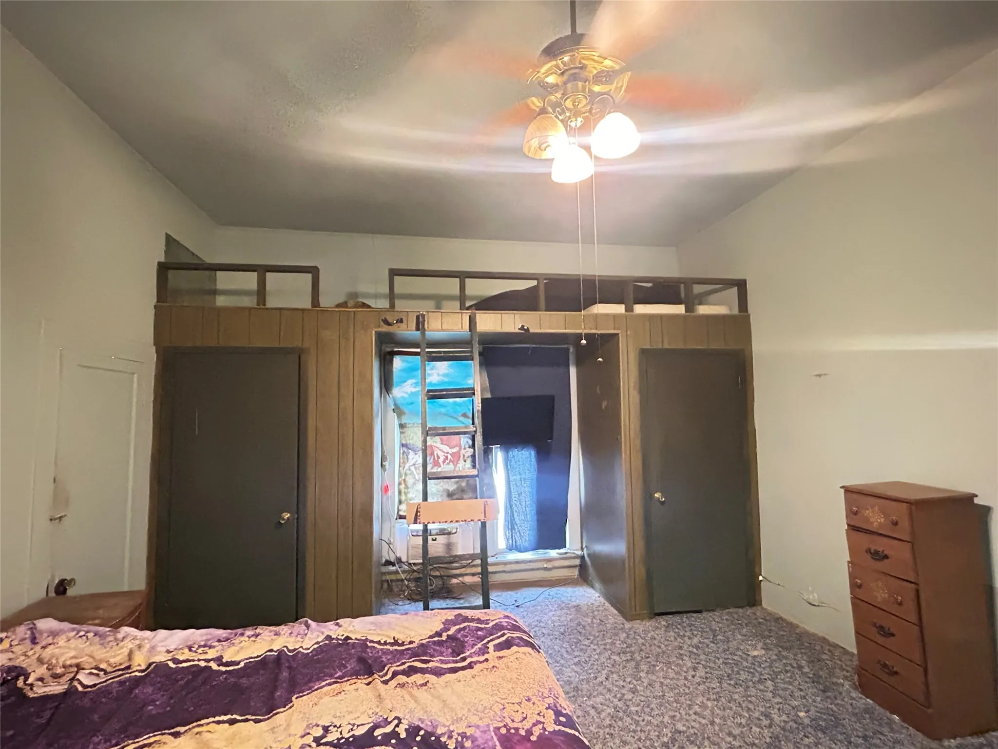  This is your Primary Bedroom with a Loft area, 2 Closets, a large picture window, & a ceiling fan with lights.