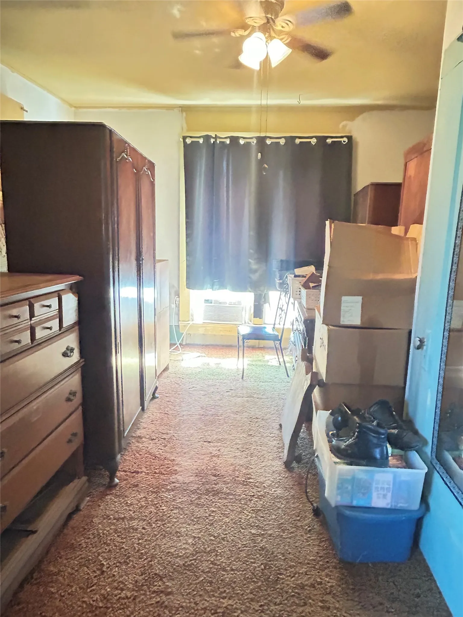 This is a front Bedroom with a large window, carpet, ceiling fan with lights. ALL of the items in this room DO NOT transfer. The owner will clear this room out prior to Closing.