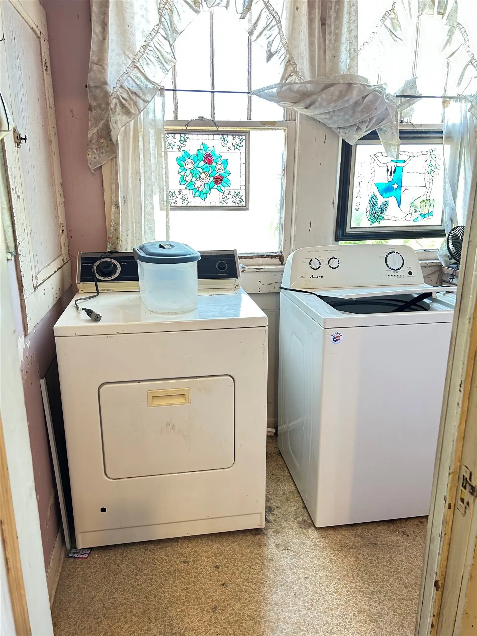 A lovely laundry room with windows for plenty of natural light.