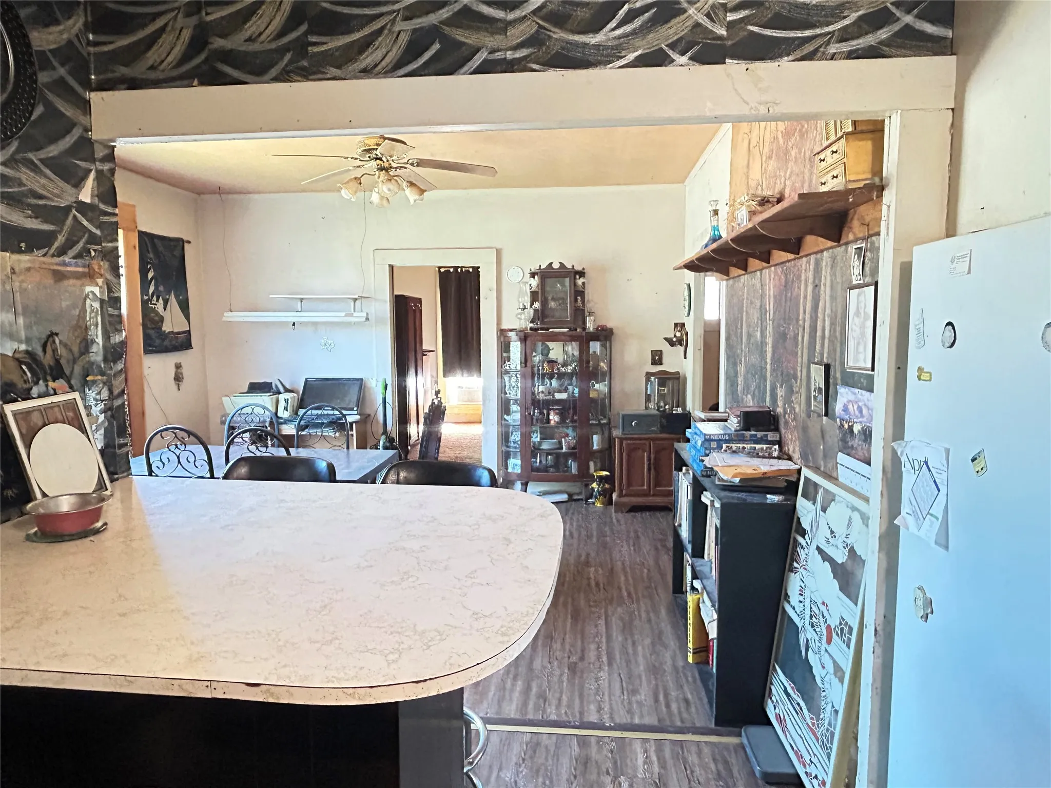 A breakfast bar area in the kitchen as you look into the dining room.
