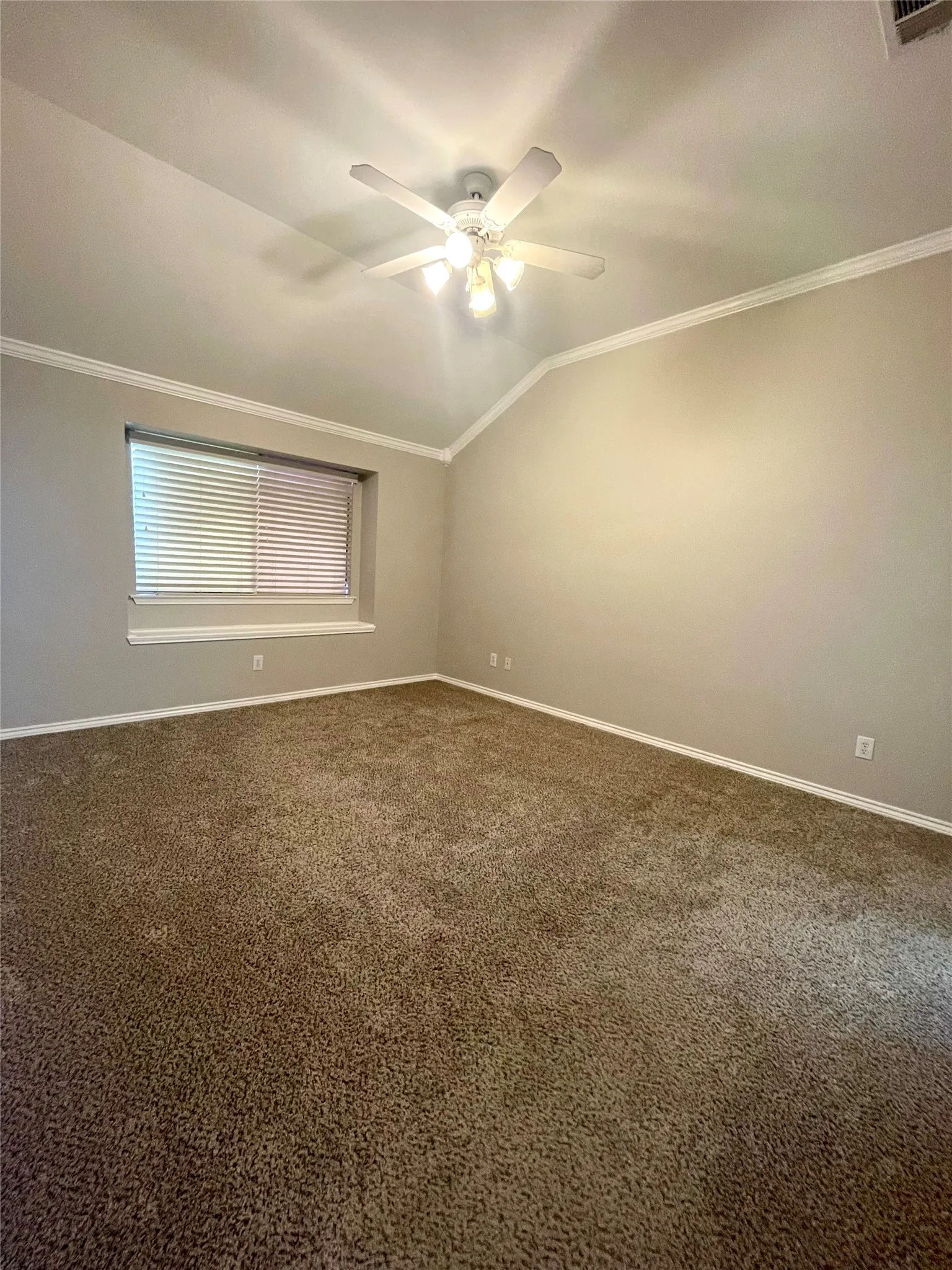 Good size primary bedroom with crown moulding