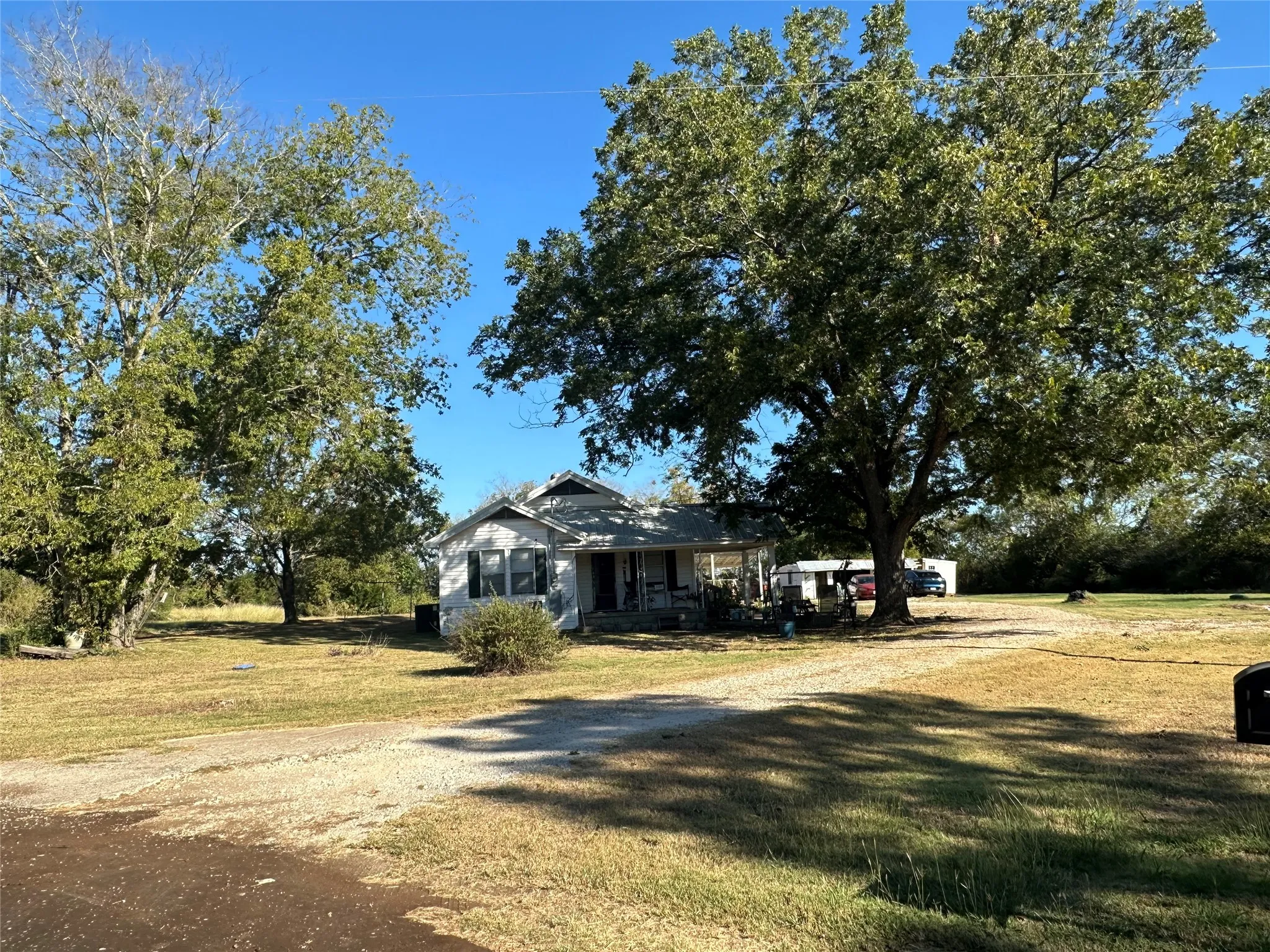 Single-story property with light-colored siding and a covered front porch
