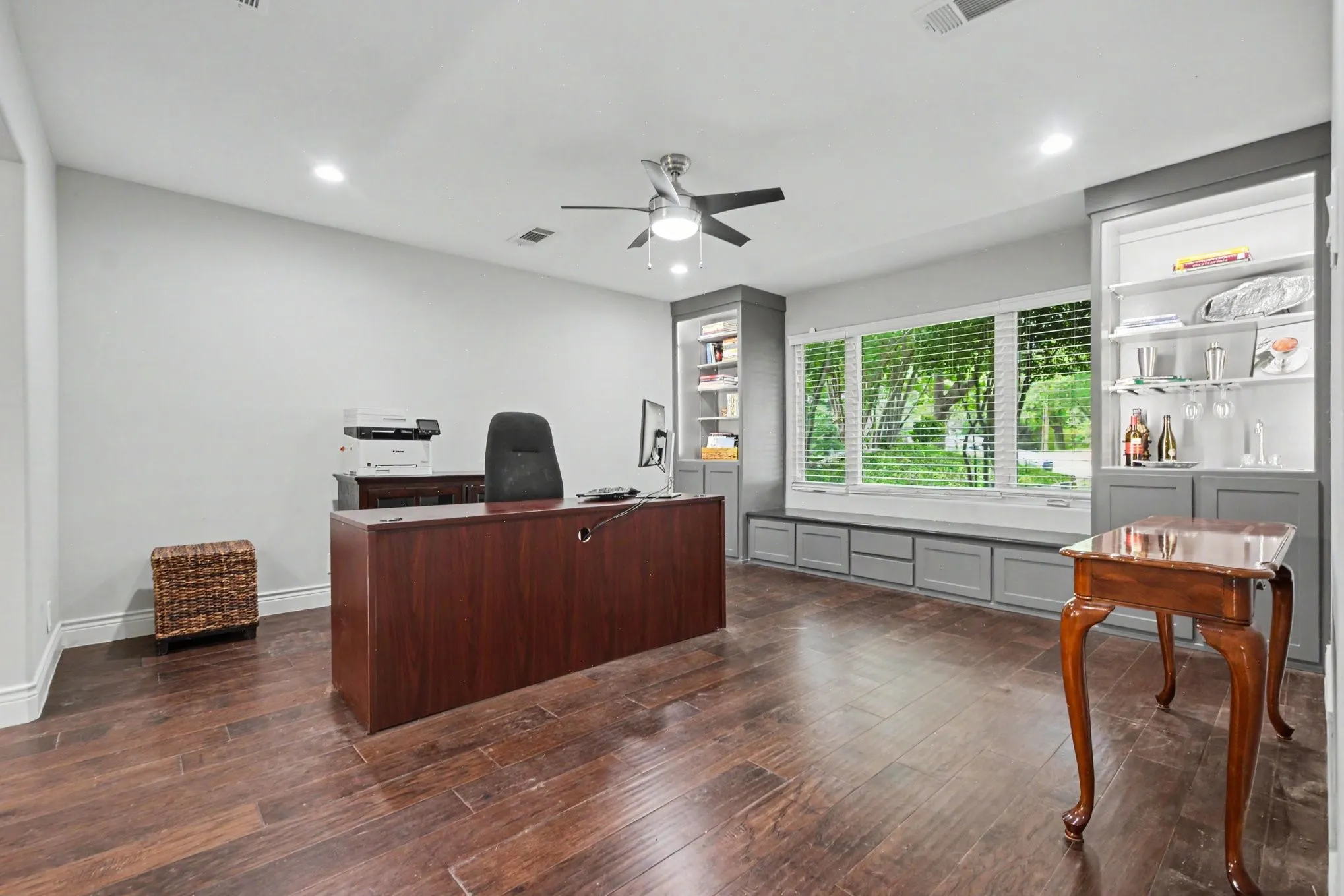 Spacious interior room featuring wood-finish flooring, recessed lighting, and a ceiling fan