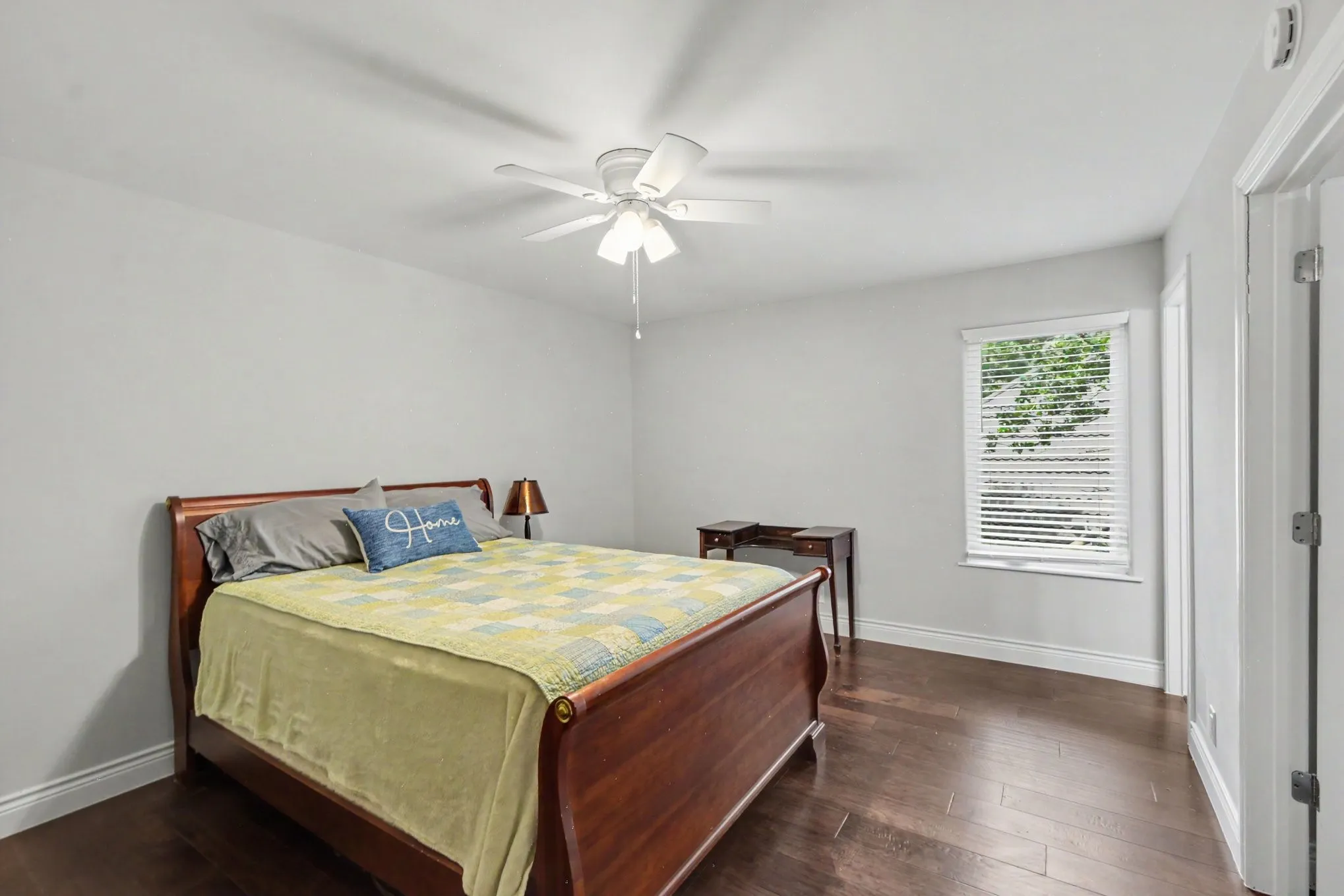 Room featuring dark wood-finish flooring, light neutral-toned walls, and white trim