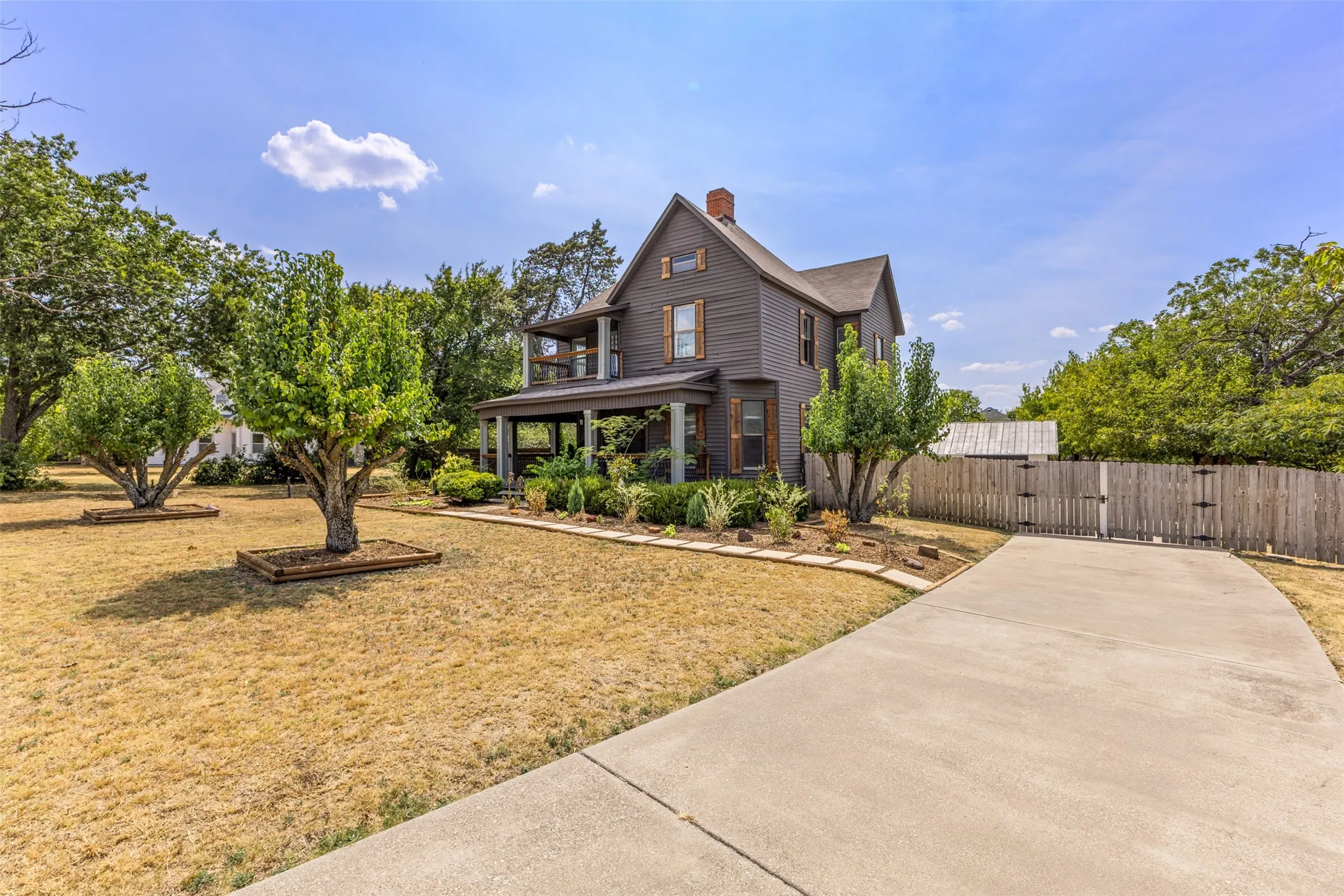 Two-story home with a wrap-around porch and second-story balcony