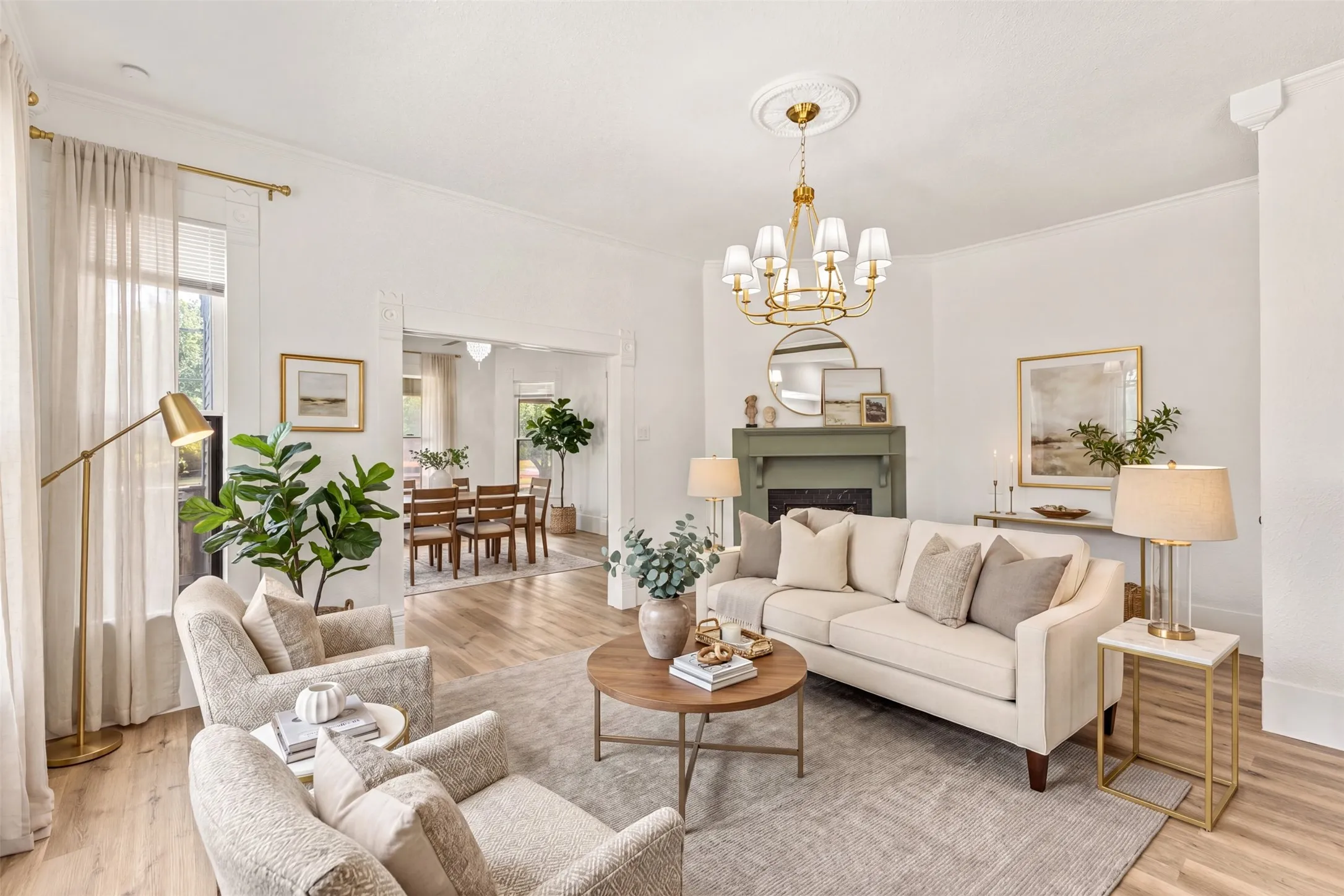Recessed fireplace with mantel, crown molding, chandelier lighting, and wood-finish flooring