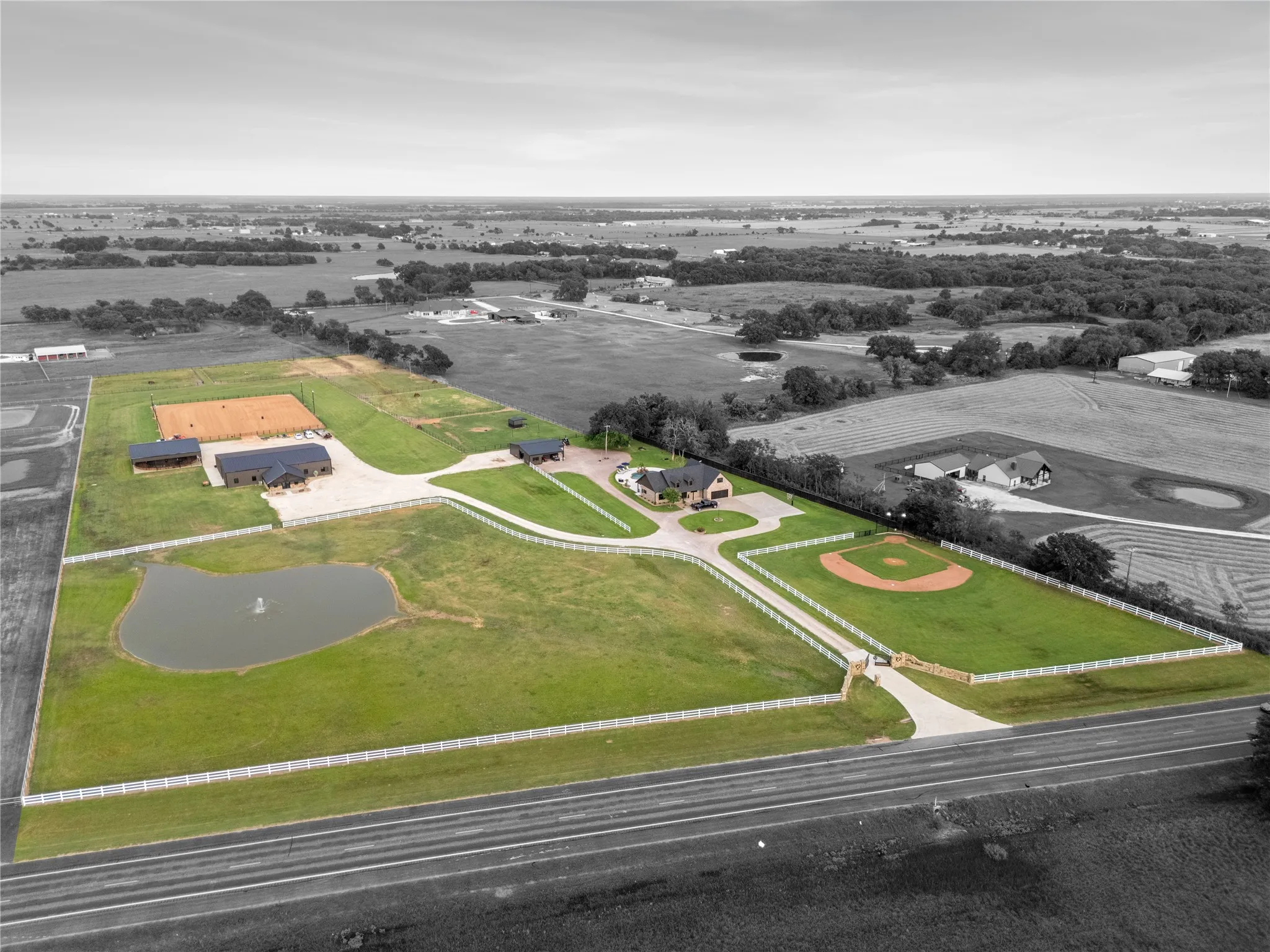 Aerial view of property layout. A true stay-home vacation resort featuring swimming, horseback riding, basketball, and a full baseball field.