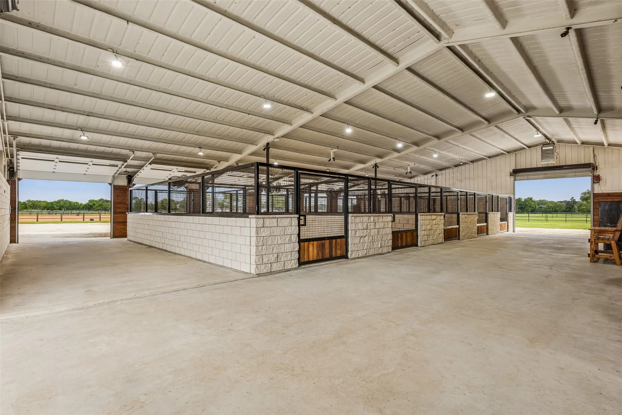 11 stall 14 x 18 horse stalls, matted with, classic equine waters, fans, noble hay feeders and cameras for each stall.
