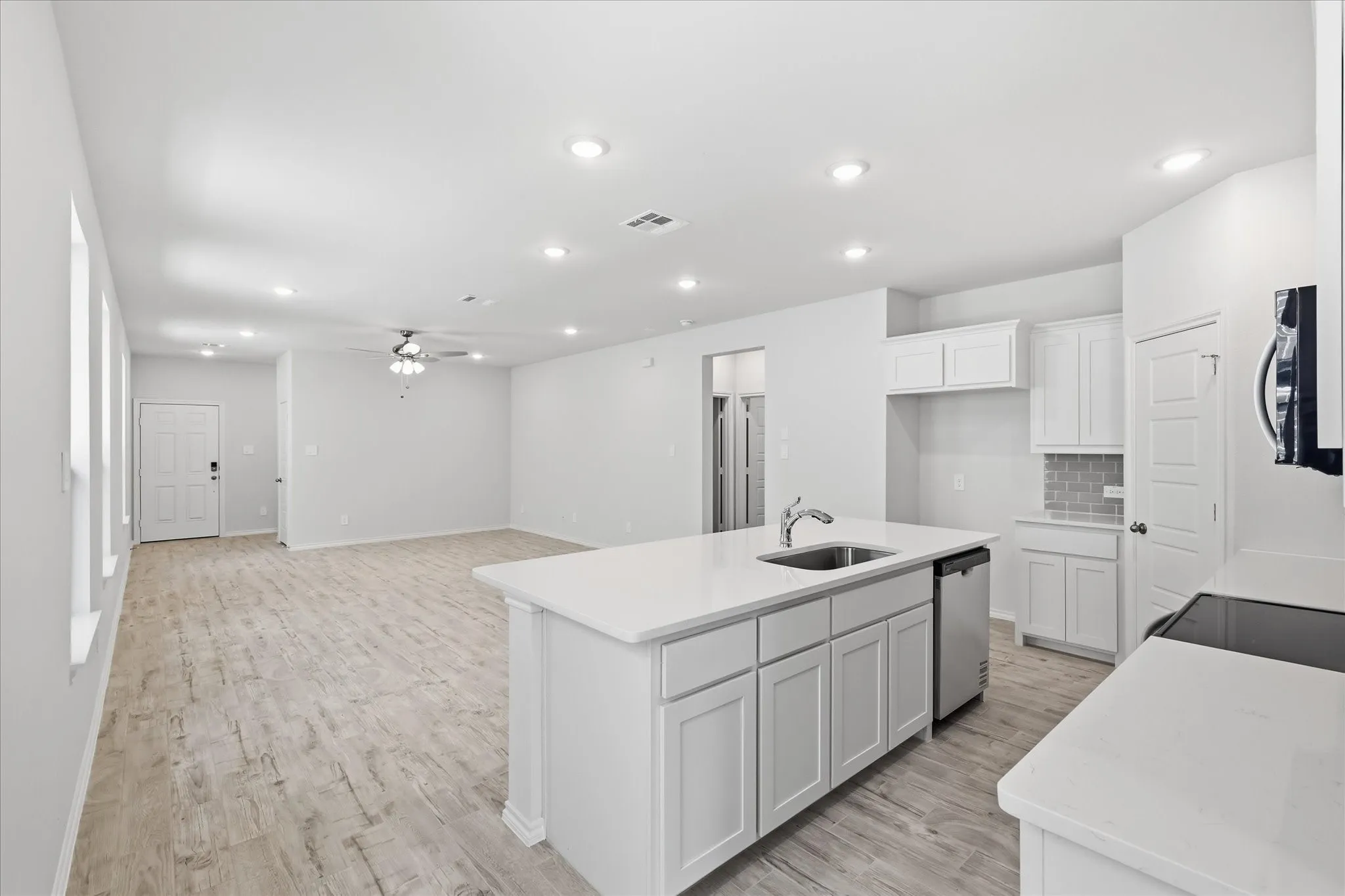 Open-concept living space featuring wood-finish flooring throughout