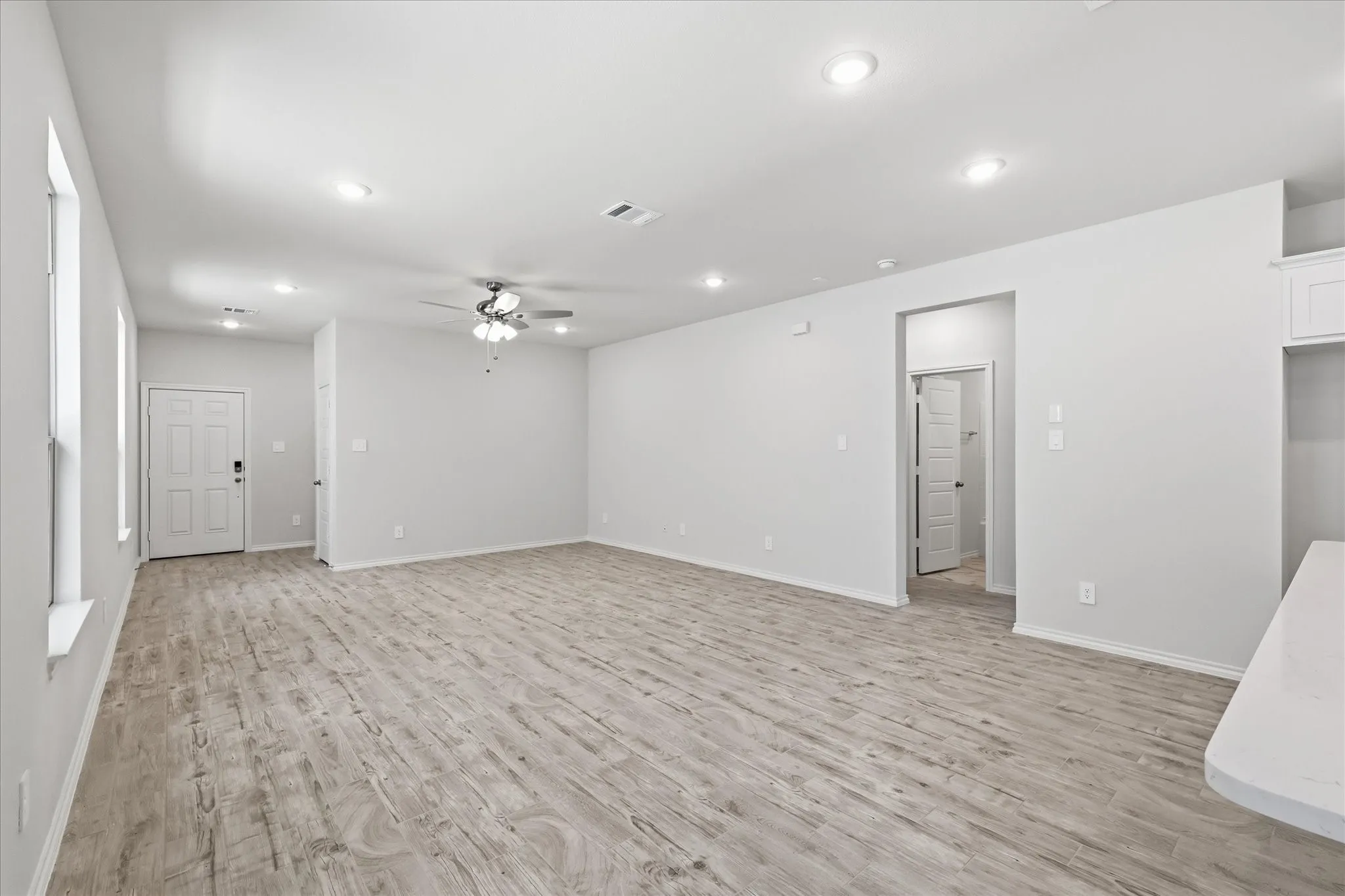 Viw of the entry way and living room.  The opening to the right takes you to the two secondary bedrooms and the guest bathroom.