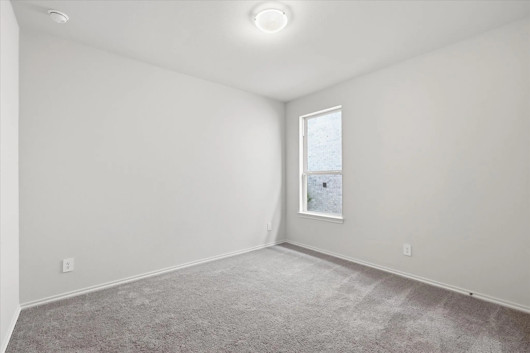 Seondary bedroom with carpet and nuetral paint.