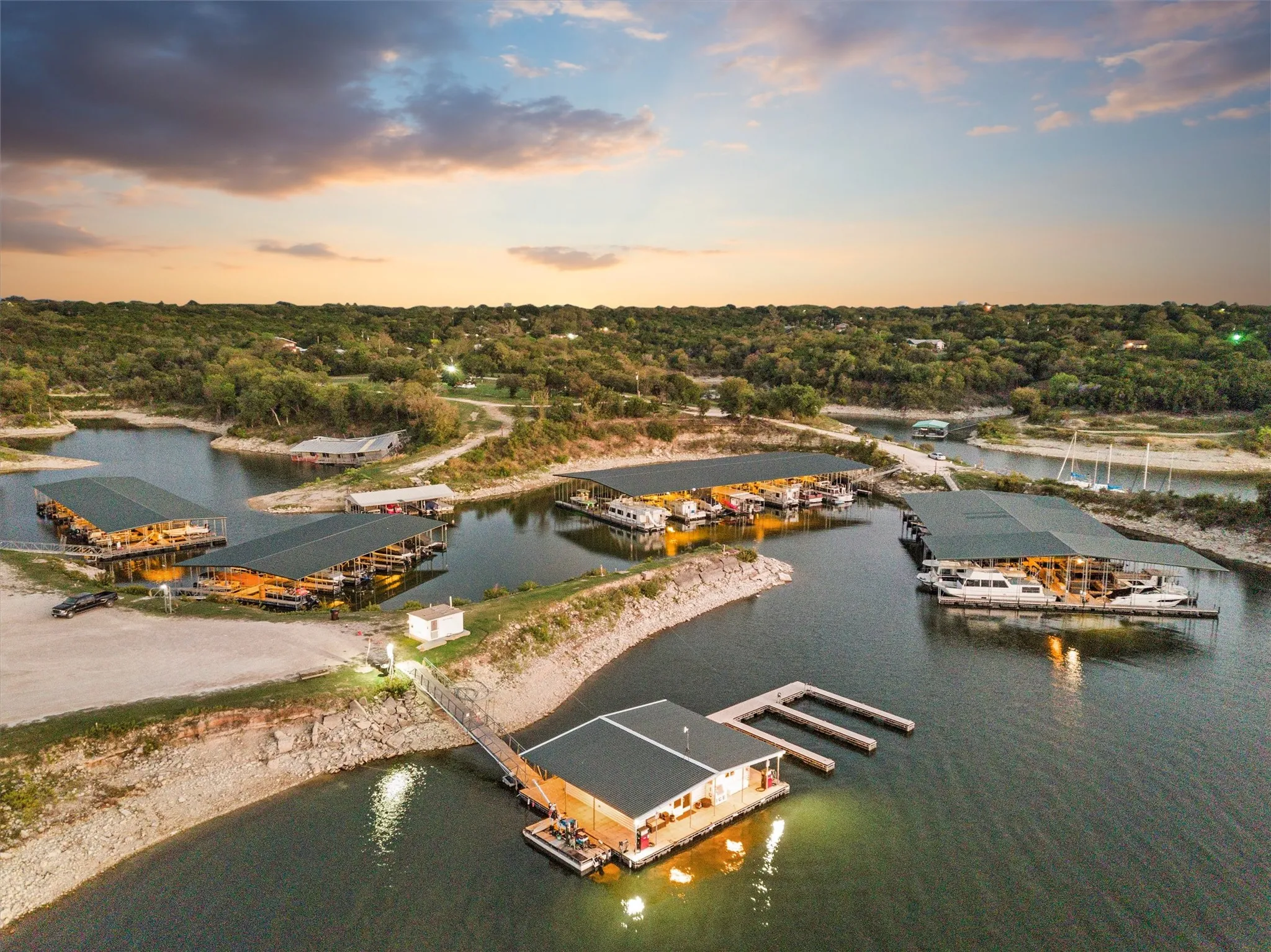 Waterfront property featuring multiple boat slips, covered docks, and a private pier