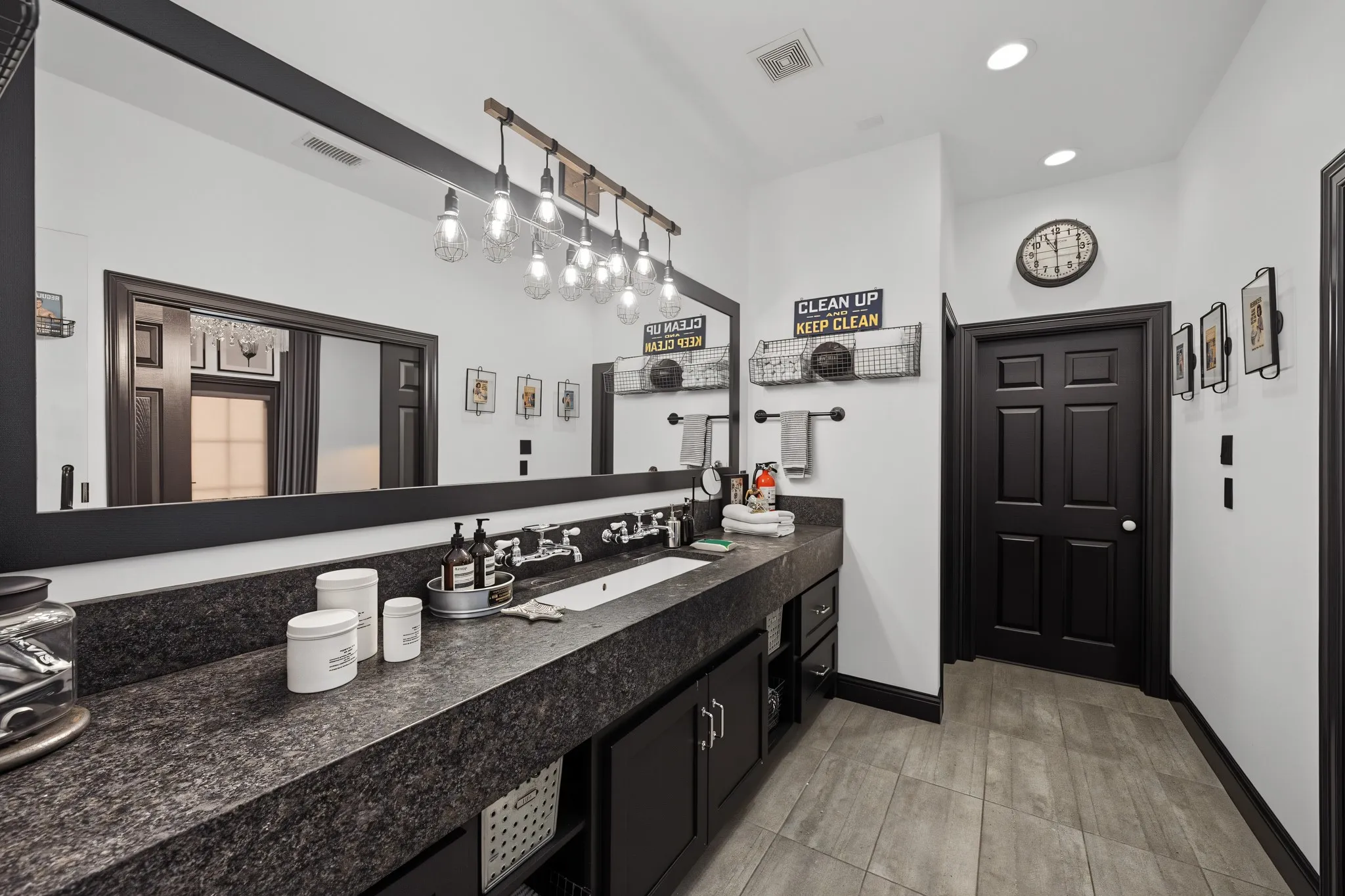 Upstairs primary bathroom with leathered granite counters.