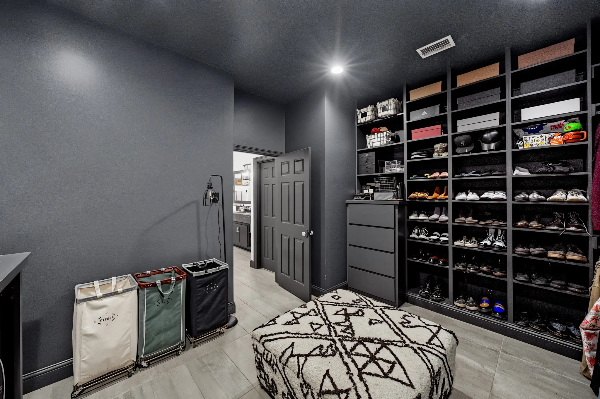 Upstairs primary walk in closet with utility area.