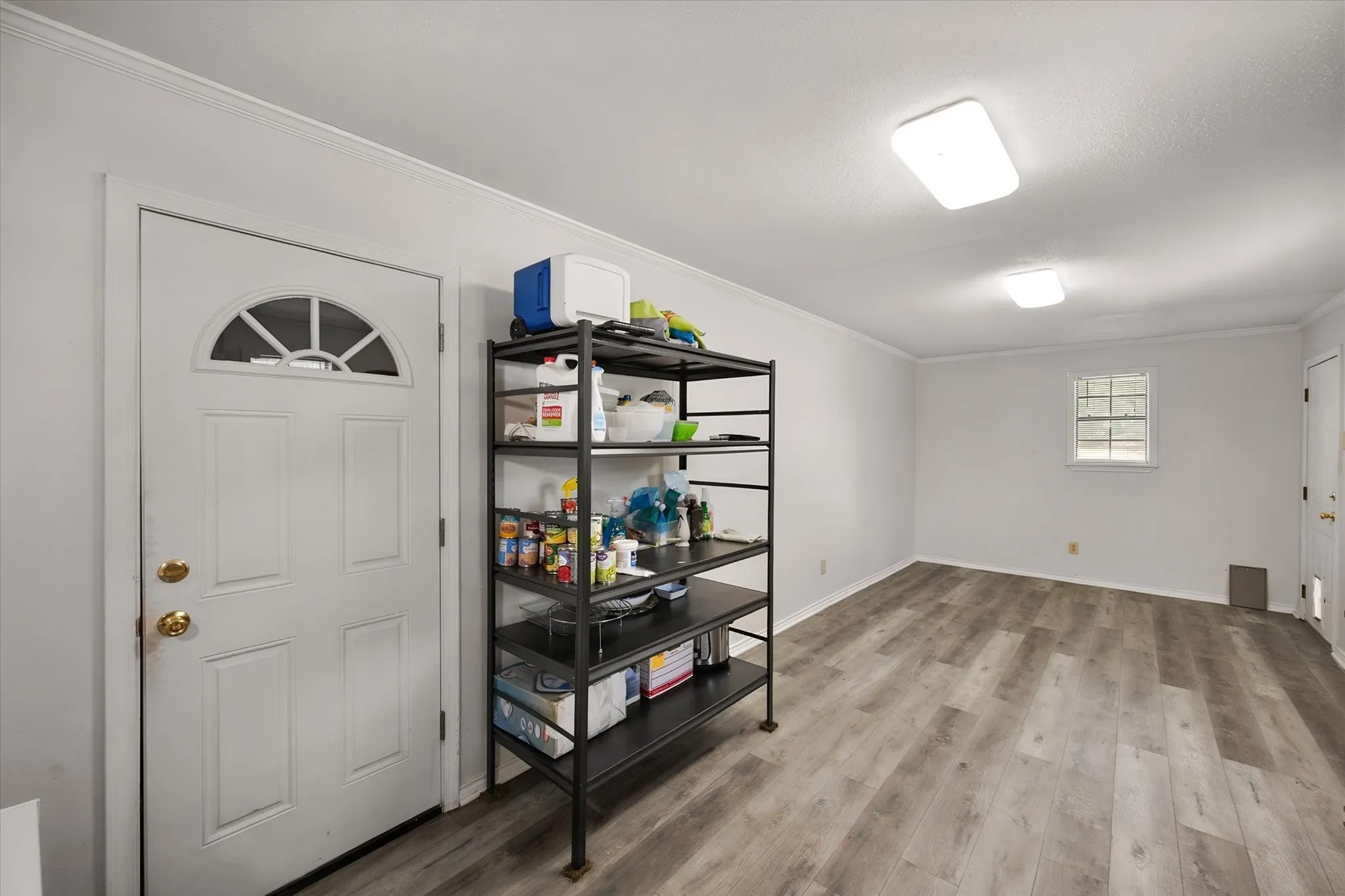 Storage or workshop area with entrance to garage.