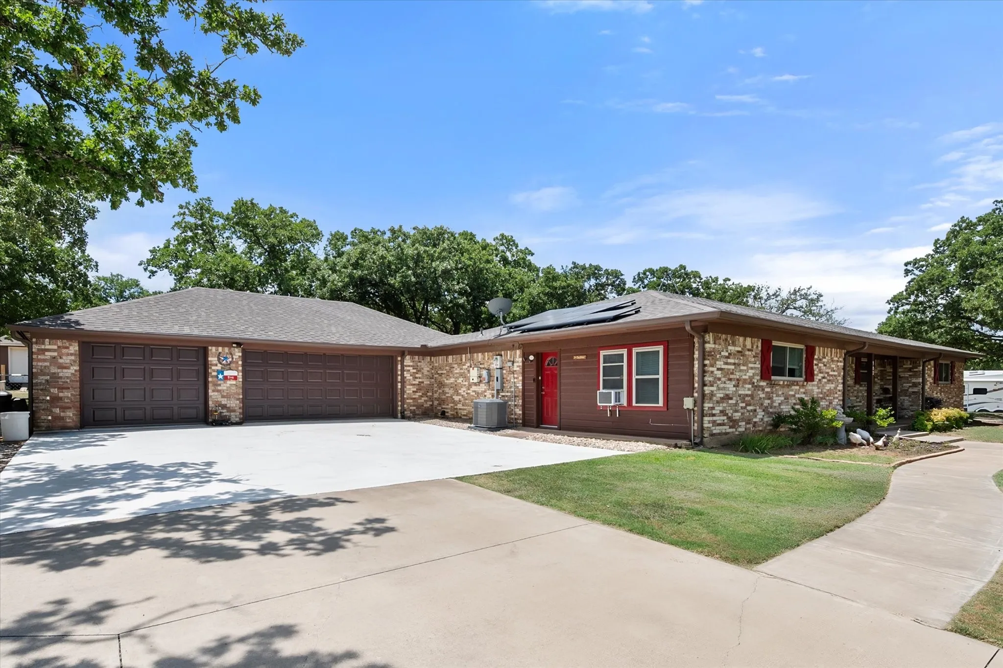 First driveway with oversized 3 car garage and side gate leading to backyard.