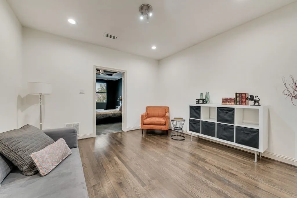 Spacious interior featuring wood-finish flooring, recessed lighting, and a white baseboard trim