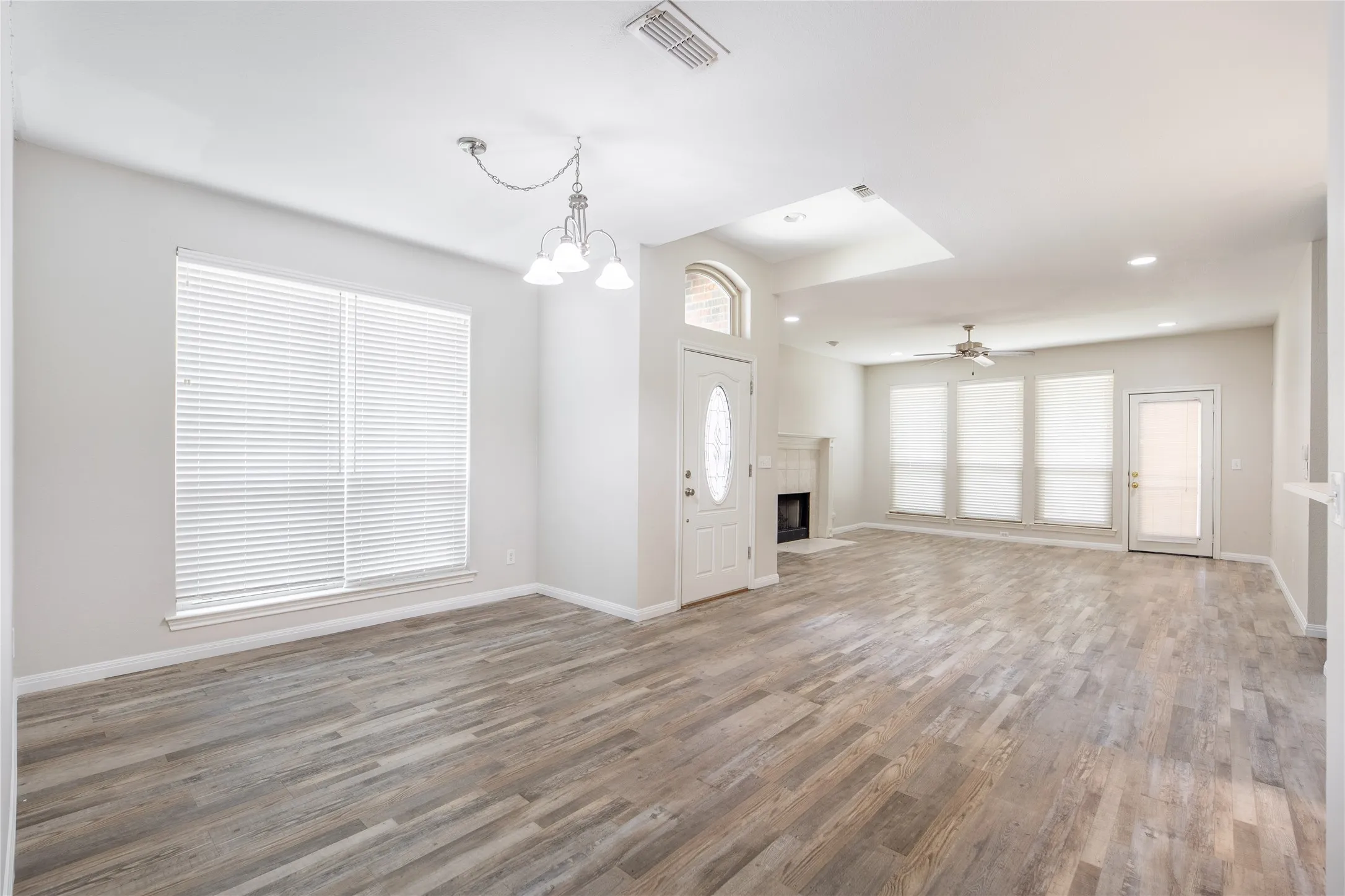 Expansive open-concept living space featuring wood-finish flooring throughout
