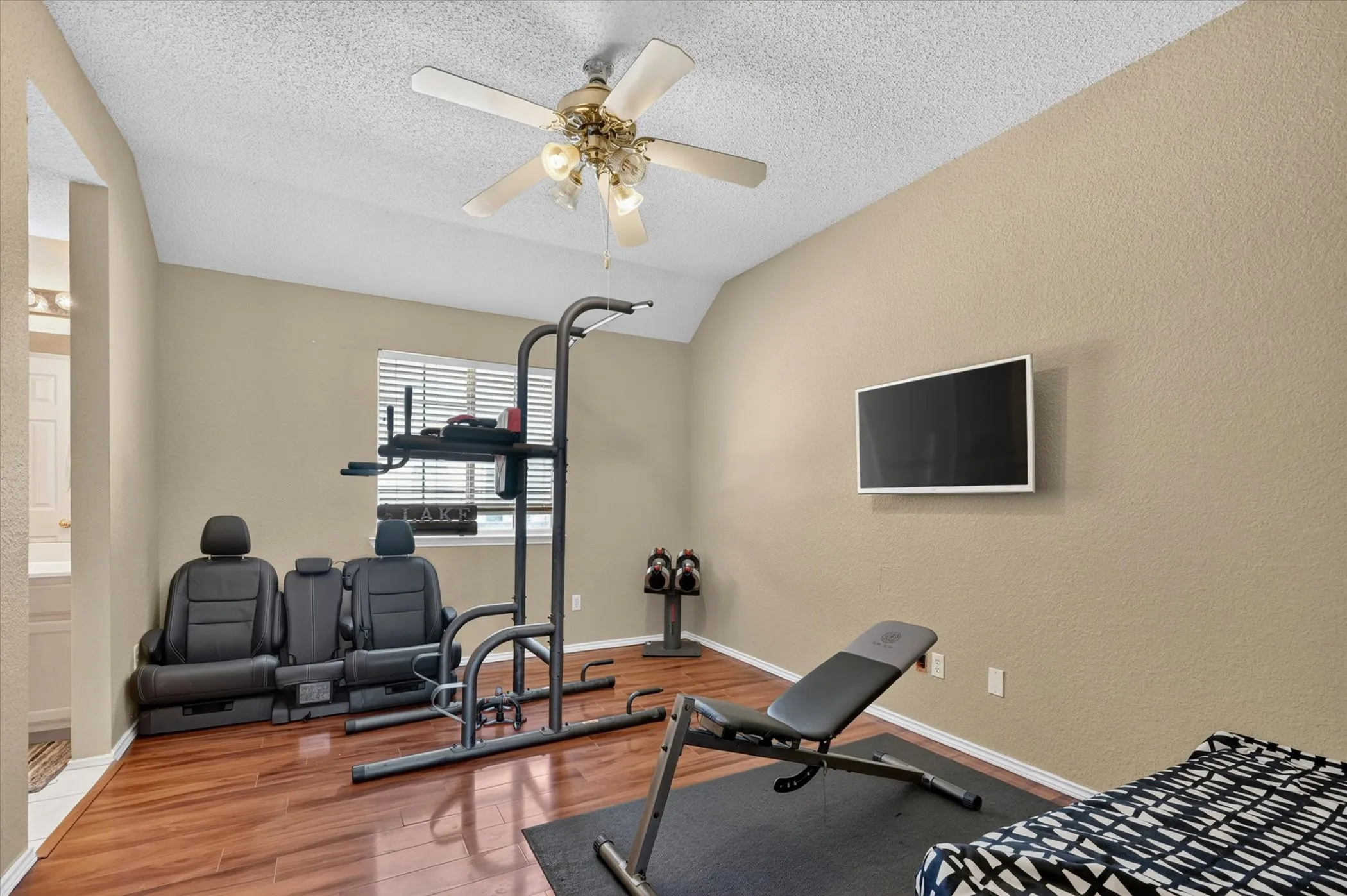 Room featuring wood-finish flooring, neutral wall paint, and a textured ceiling