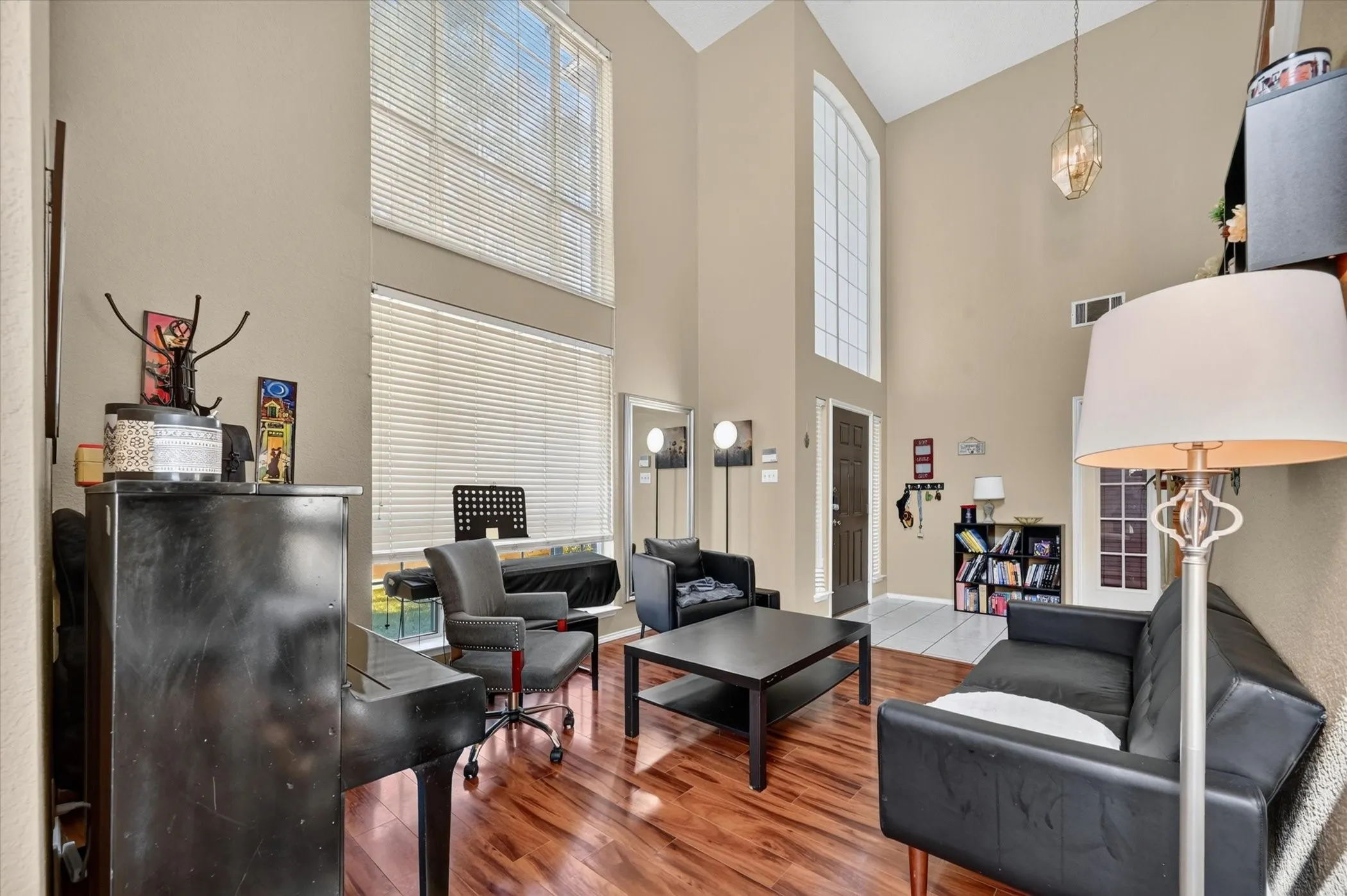 Living area with vaulted ceilings and wood-finish flooring