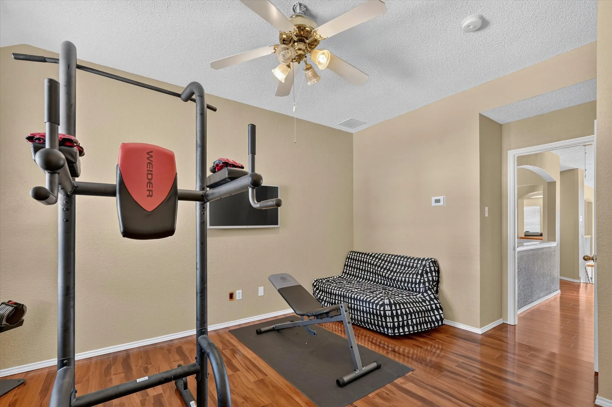 Versatile room featuring wood-finish flooring and neutral wall tones
