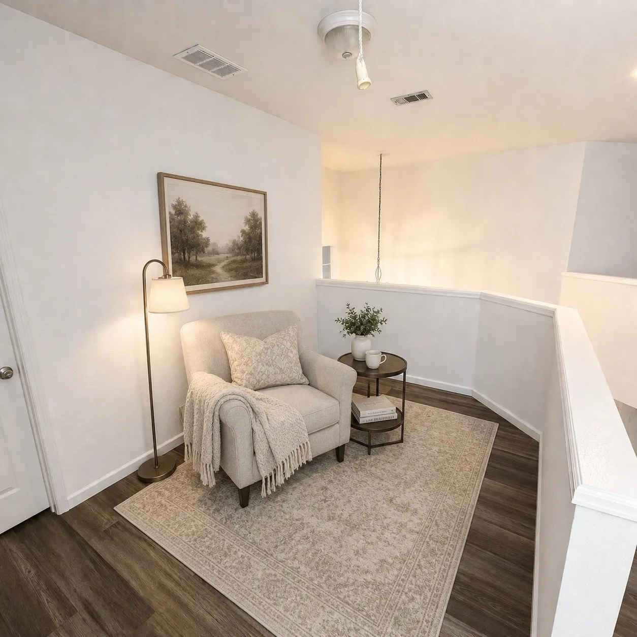 Upper-level landing featuring wood-finish flooring, white walls, a white railing, and recessed lighting
