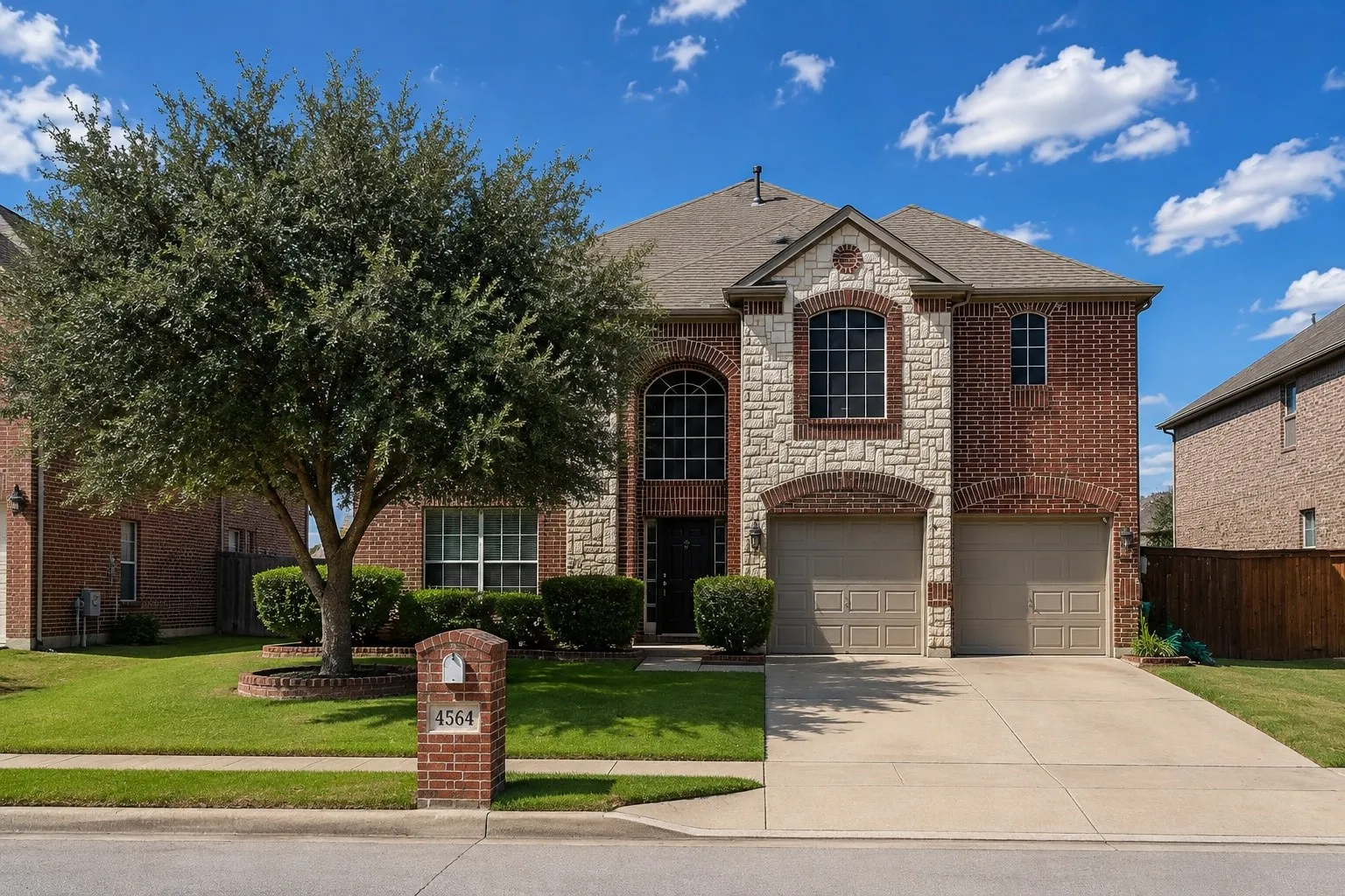Two-story brick and stone exterior featuring arched windows