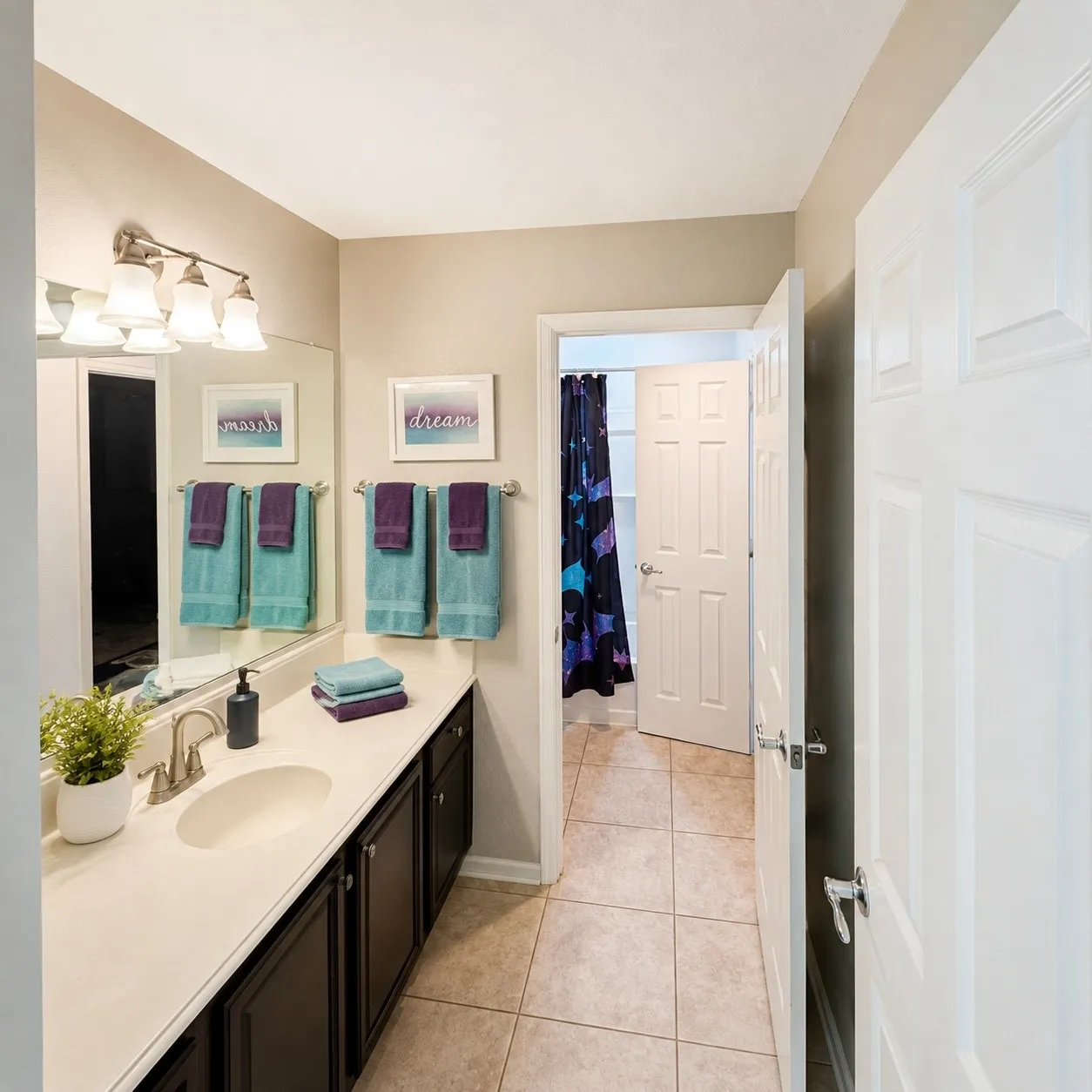 Bathroom featuring a vanity with a light-colored countertop and under-mount sink