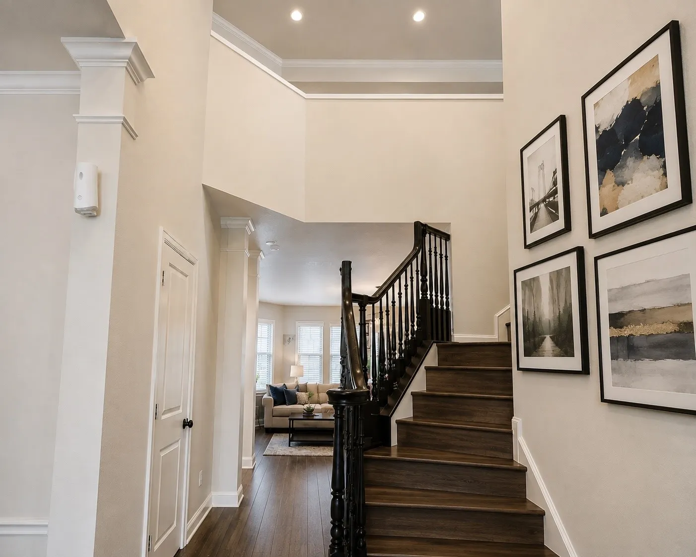 Double-height foyer with recessed lighting and crown molding