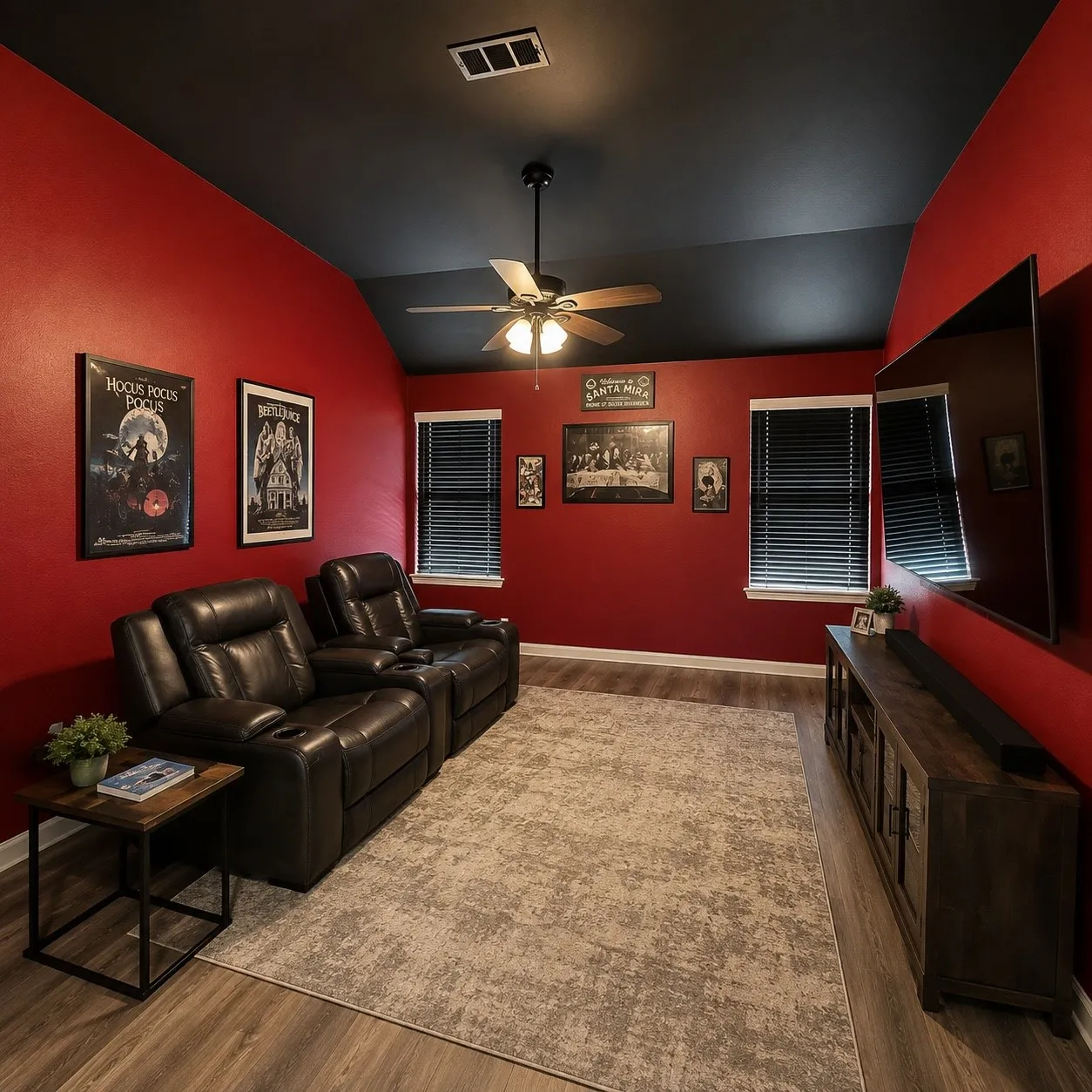 Media room featuring bold red walls and a contrasting dark ceiling