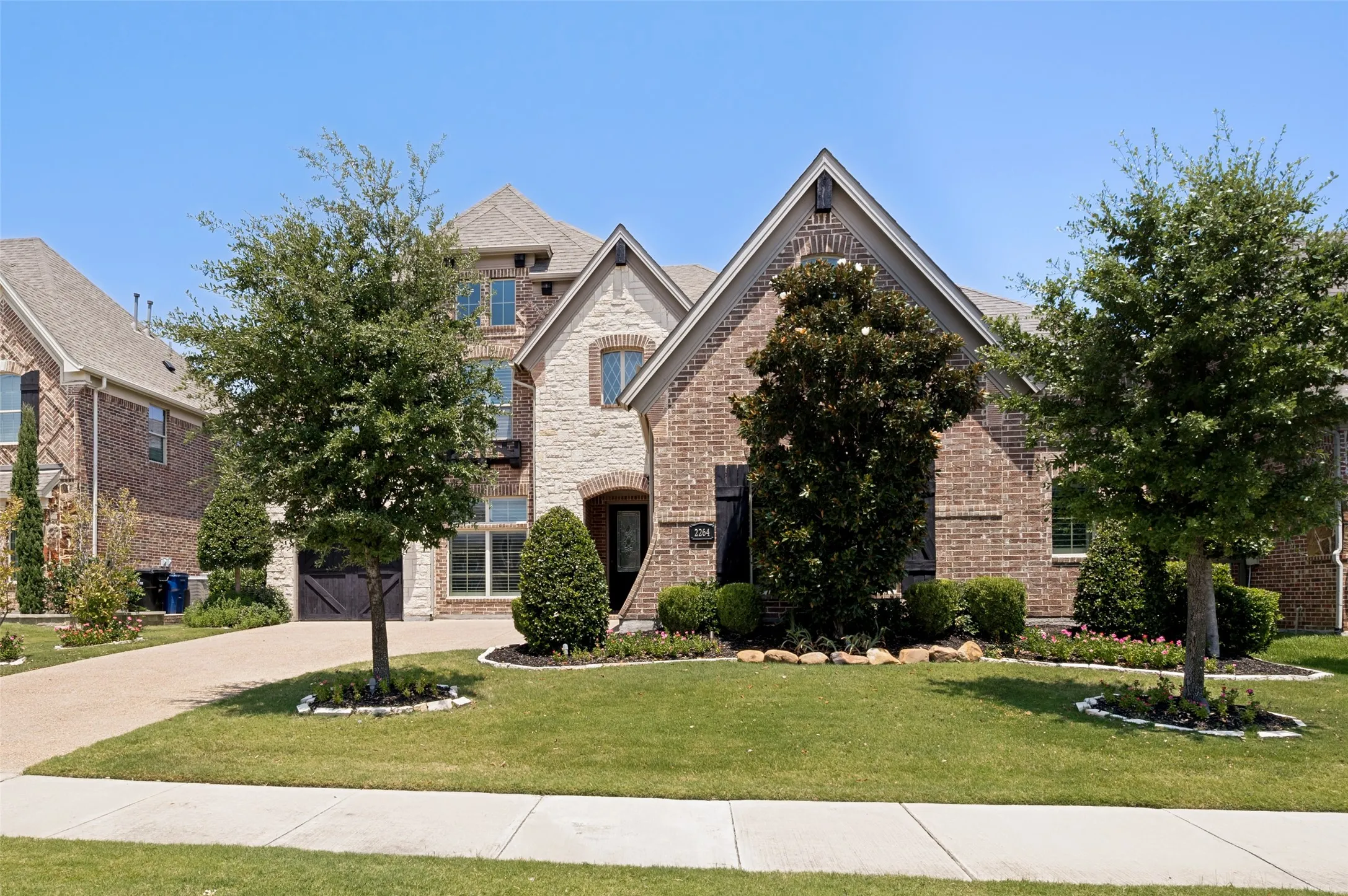 Brick and stone-clad exterior with multiple gables