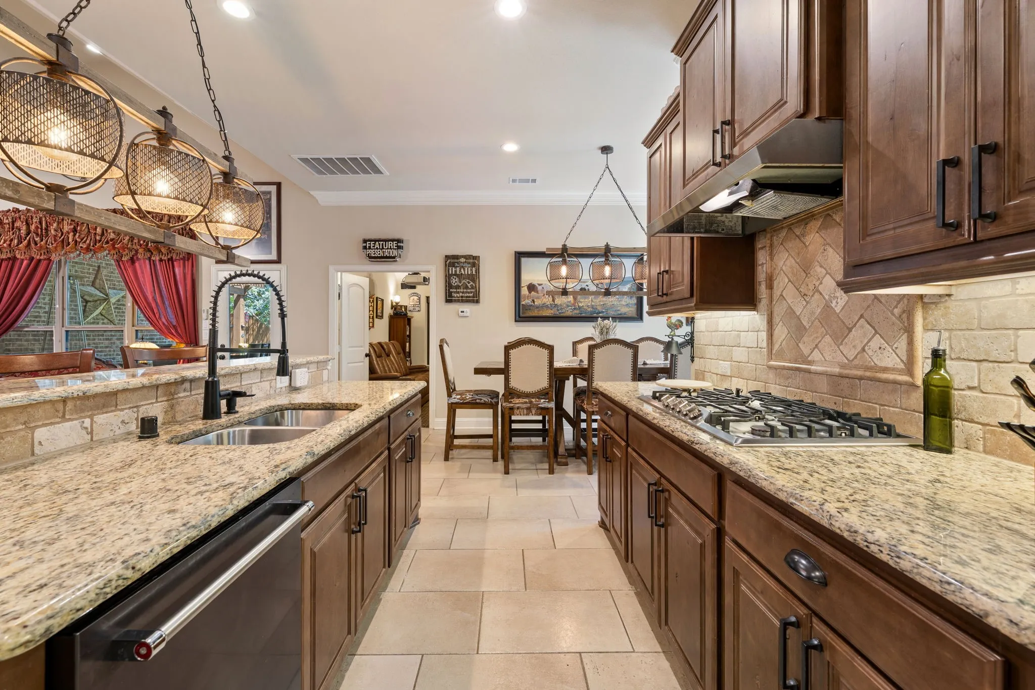 Gourmet kitchen featuring granite countertops, wood cabinetry, a gas cooktop, and tile flooring