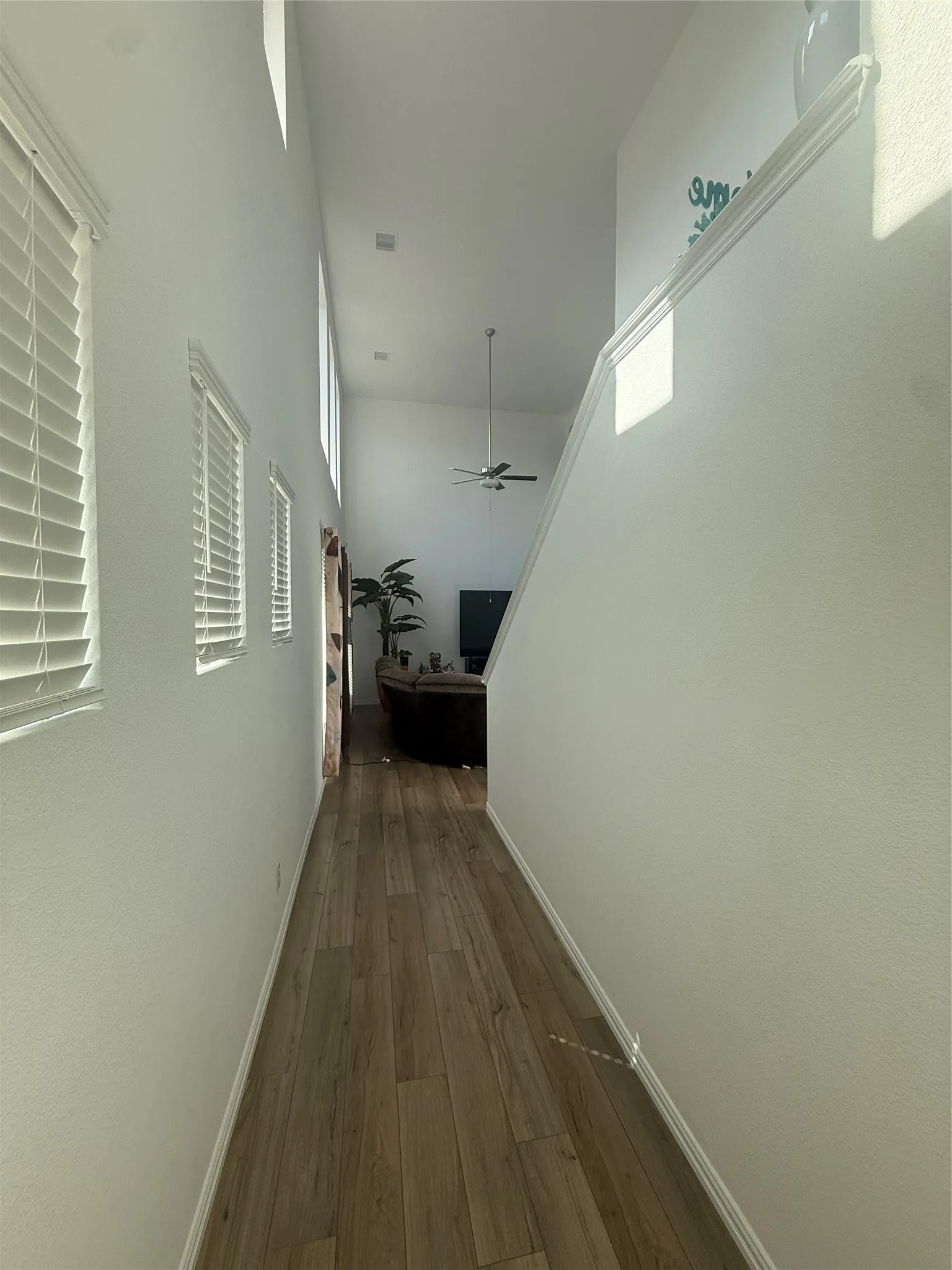 Open-concept living area with vaulted ceilings and wood-finish flooring