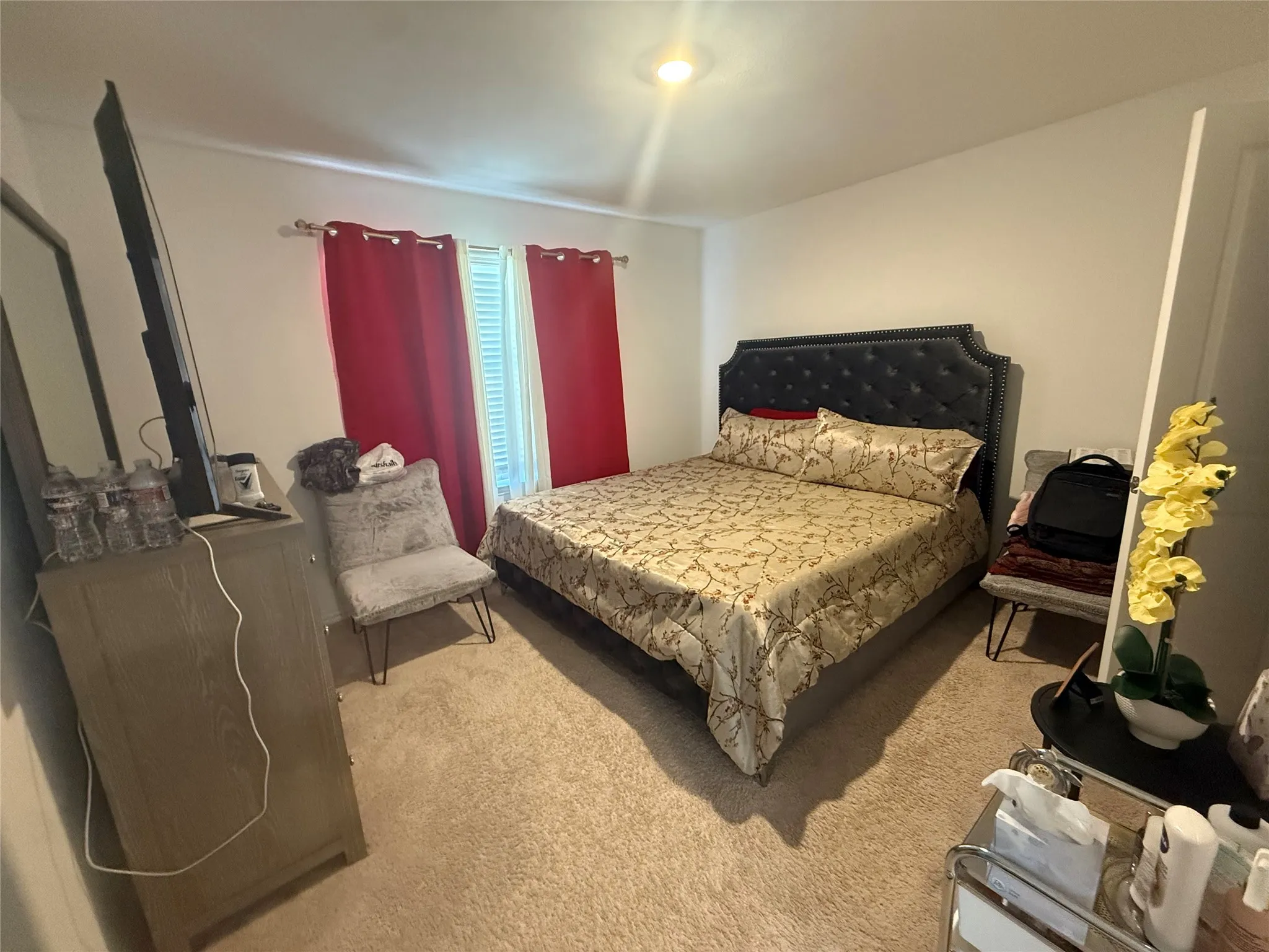 Carpeted room featuring a window with vertical blinds, a ceiling-mounted light fixture, and light-colored walls