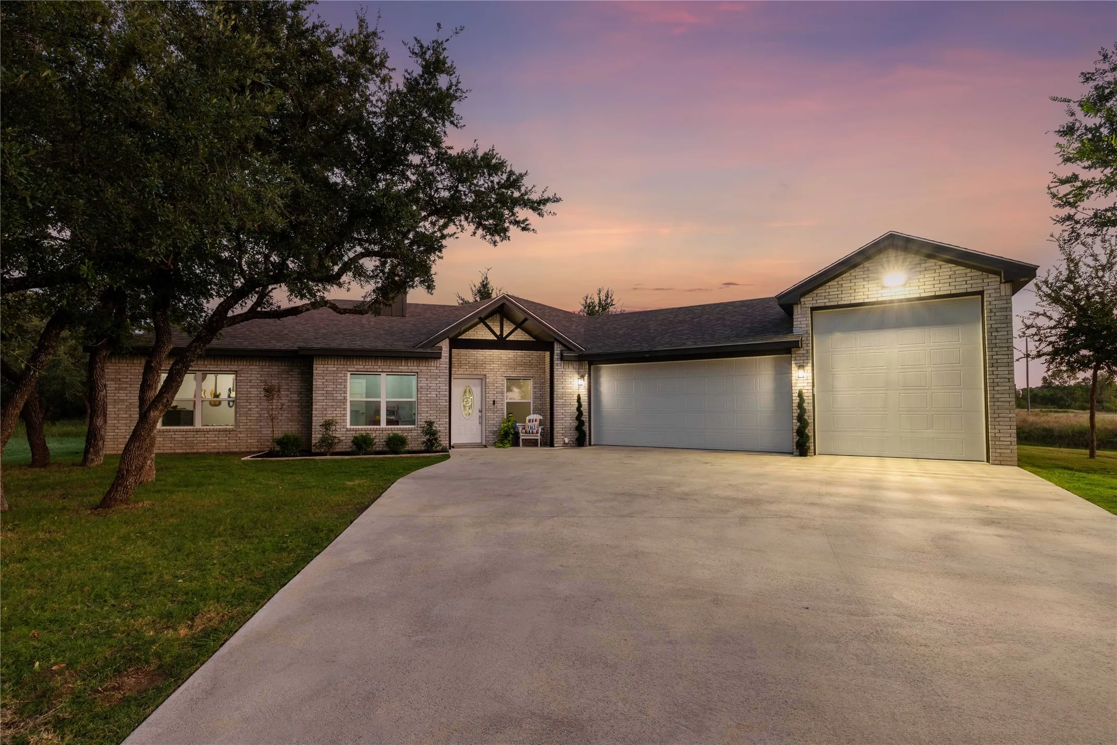 Brick exterior with a prominent two-car garage and an additional single-car garage