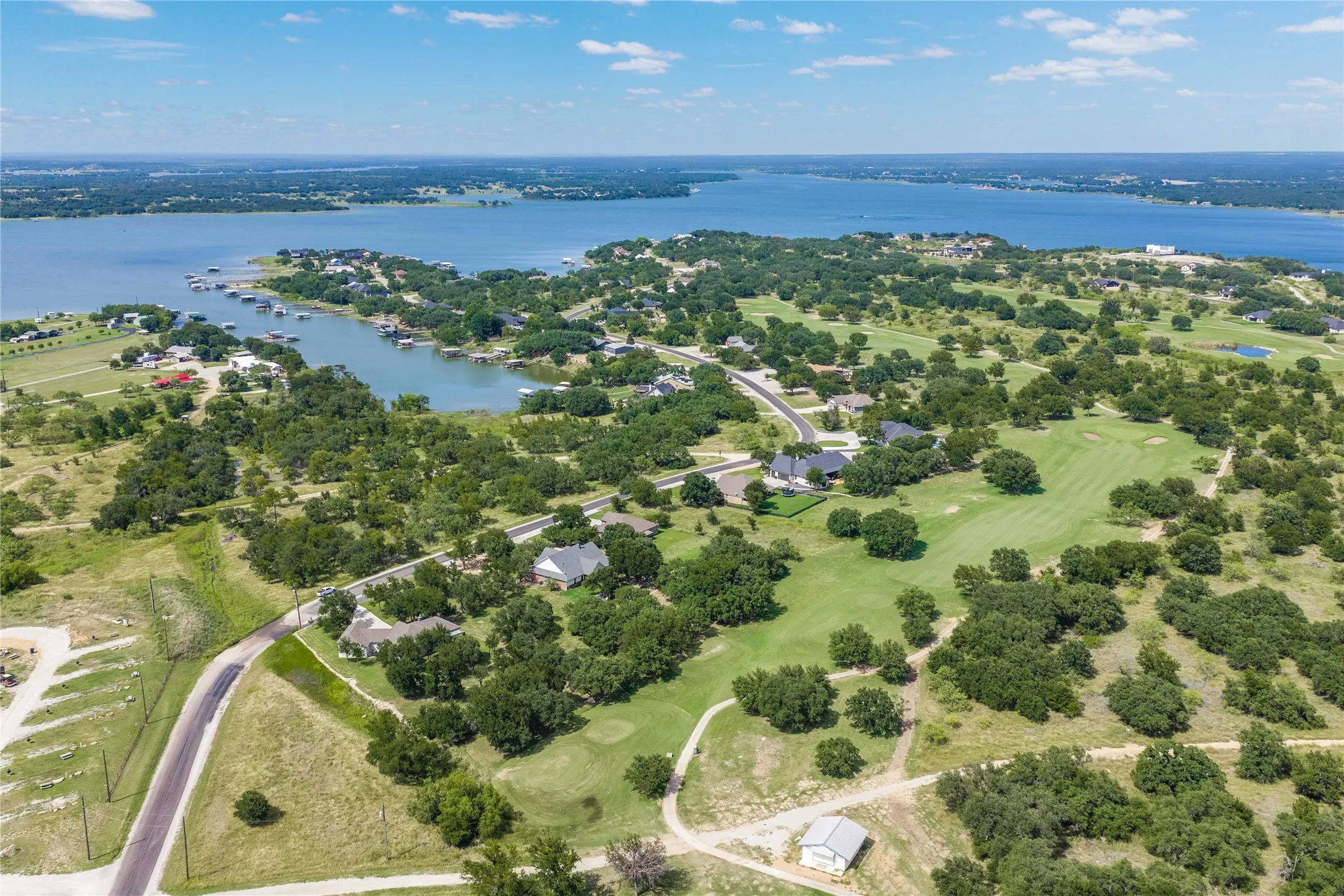 Expansive aerial perspective showcasing a significant body of water bordered by a verdant landscape