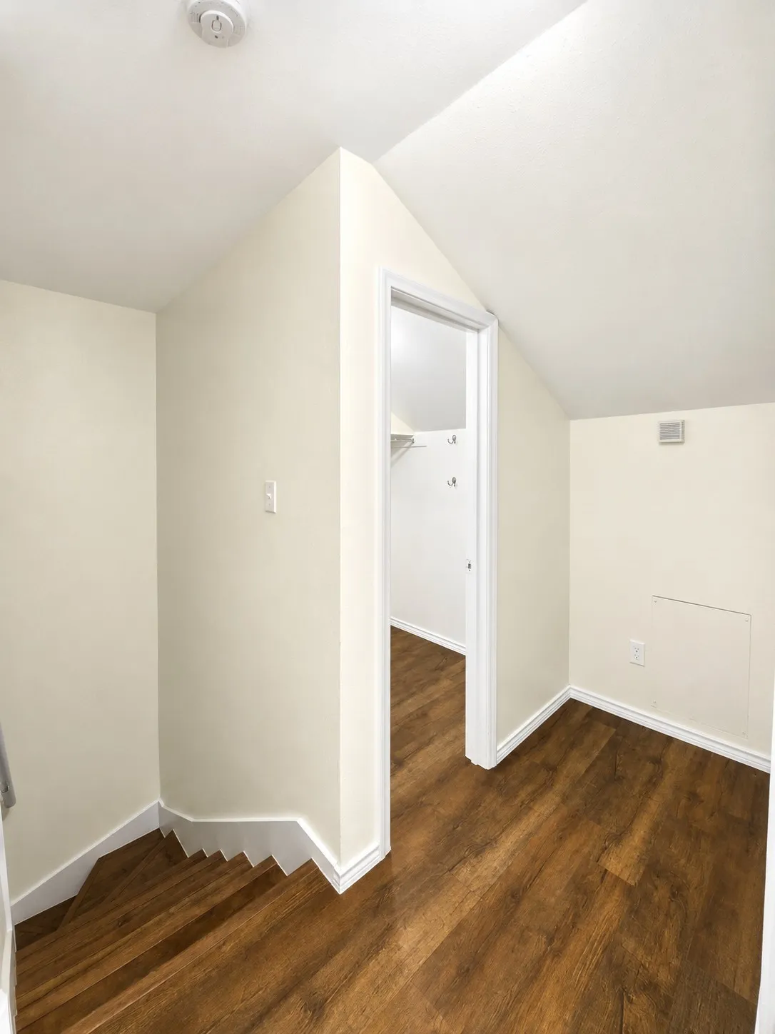 Wood-finish flooring, white trim, and a white ceiling