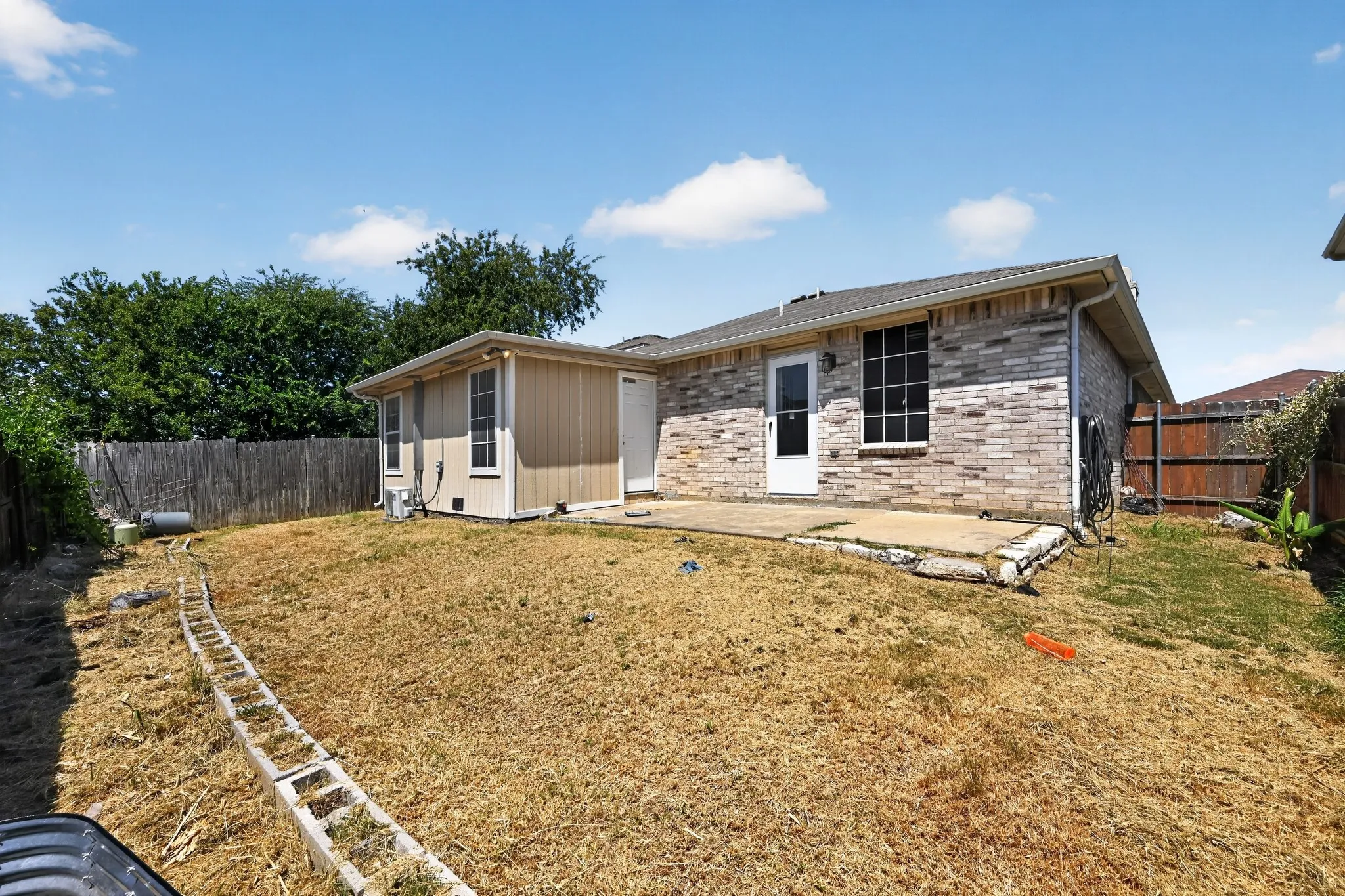 Rear exterior featuring brick and siding finishes